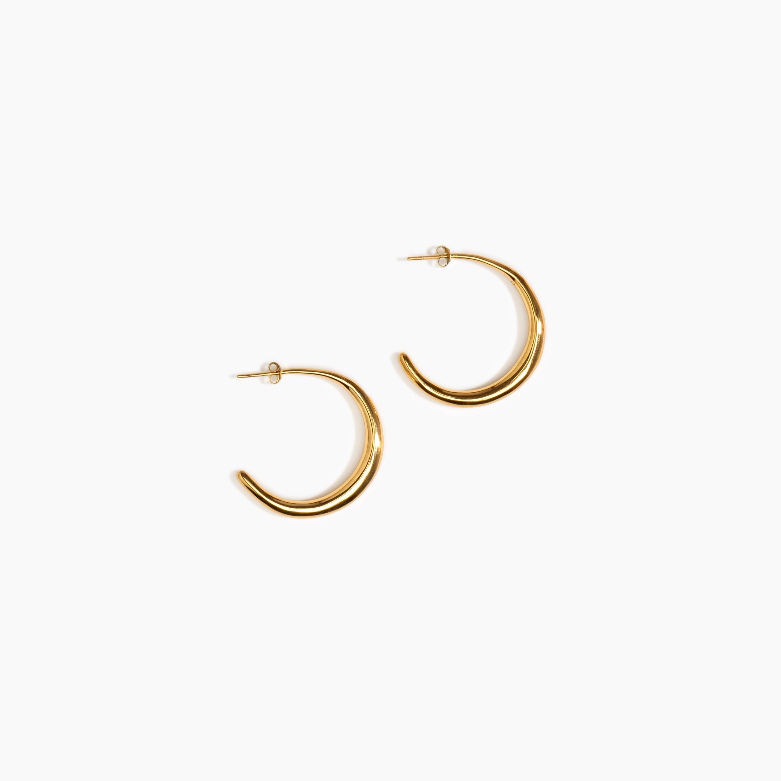 LO Collections Large Liquid Hoop Earrings in 24k Gold-Plated Brass Material..