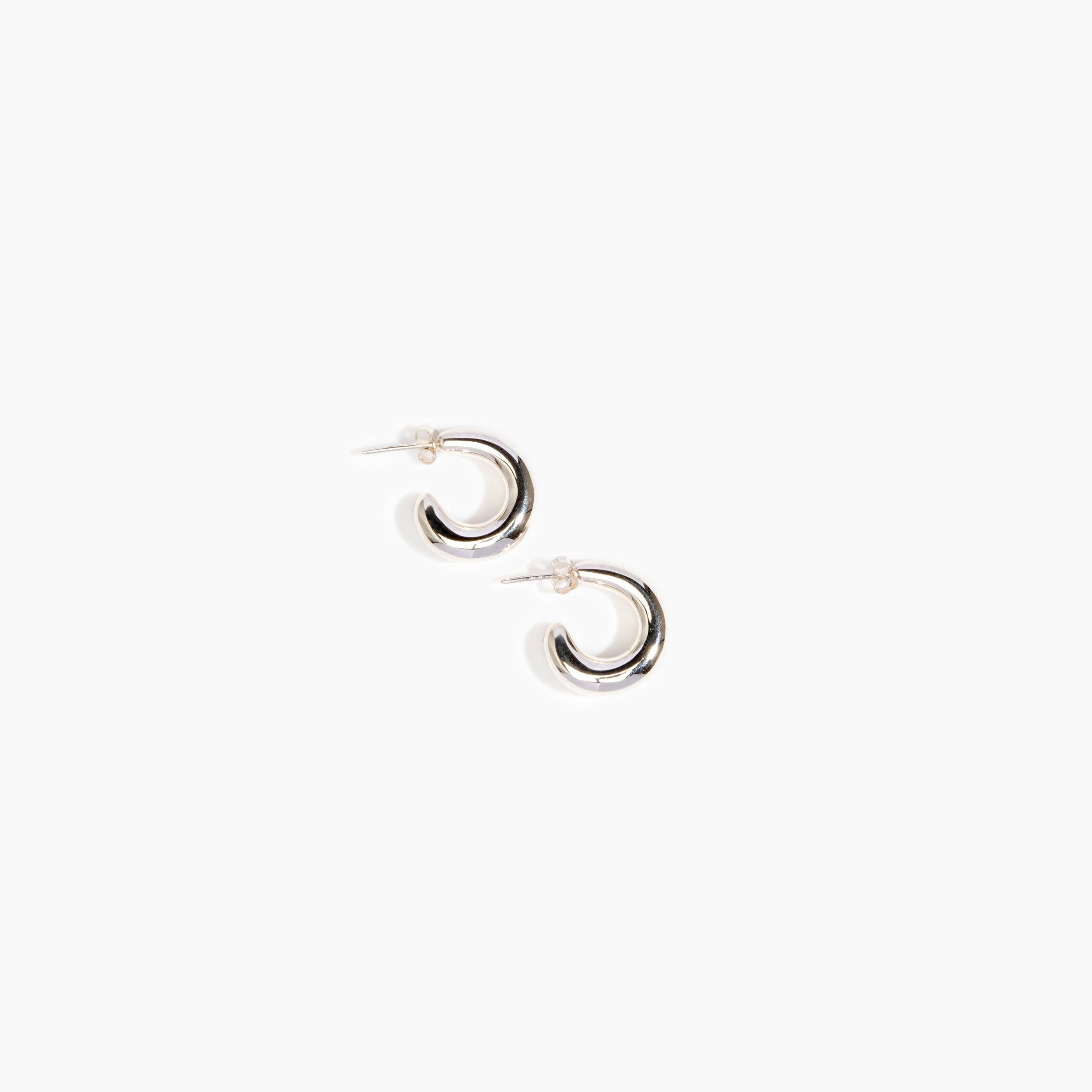 LO Collections Large Liquid Loop Earrings in Silver-Plated Brass Material..