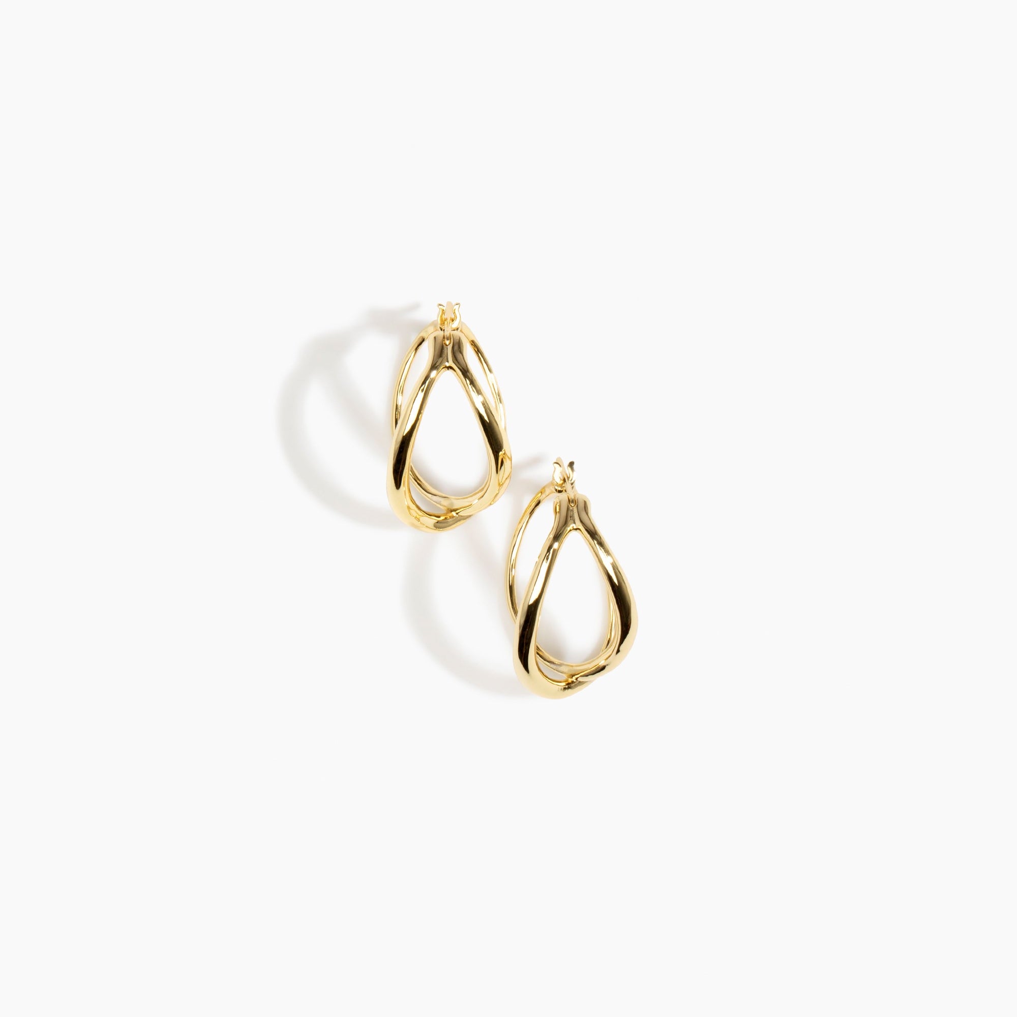 Dinosaur Designs and Alex & Trahanas Medium Corda Earrings in Brass — polished gold-toned brass hoop earrings with interlinked twisted loop design.