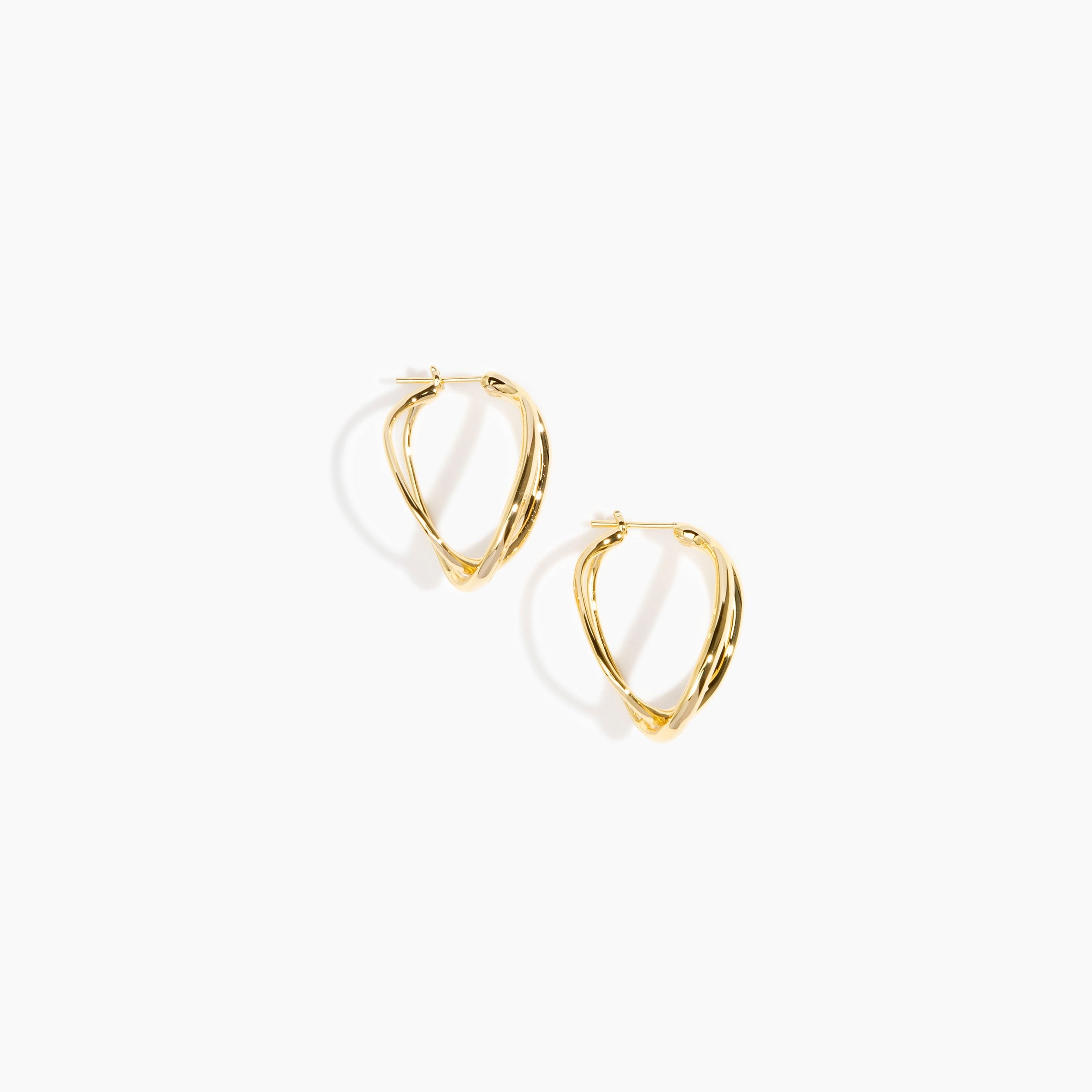 Dinosaur Designs and Alex & Trahanas Medium Corda Earrings in Brass — polished gold-toned brass hoop earrings with interlinked twisted loop design.