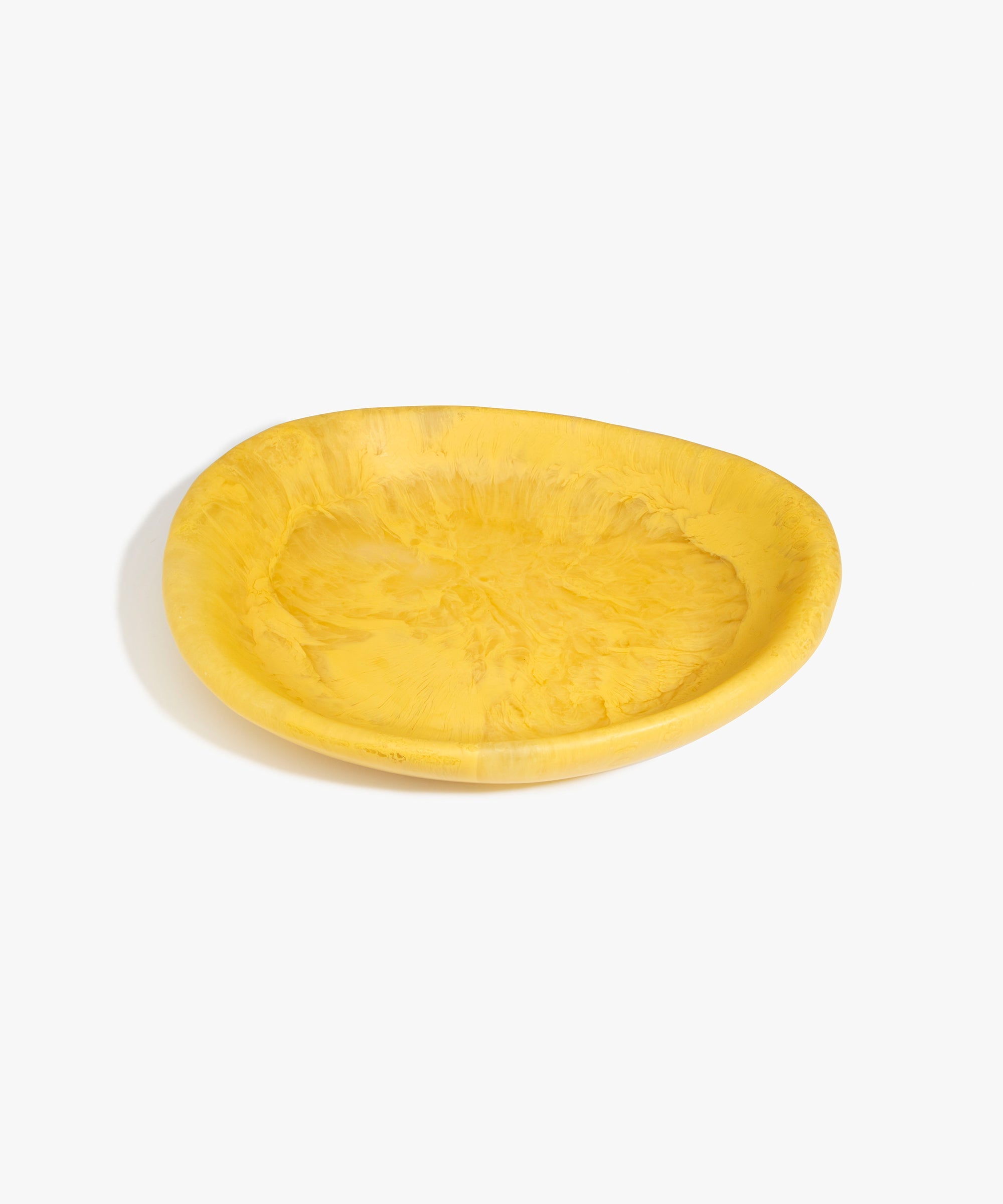 Dinosaur Designs Large Bones Bowl in Pollen — handmade marbled yellow resin shallow serving bowl with a rounded organic form...