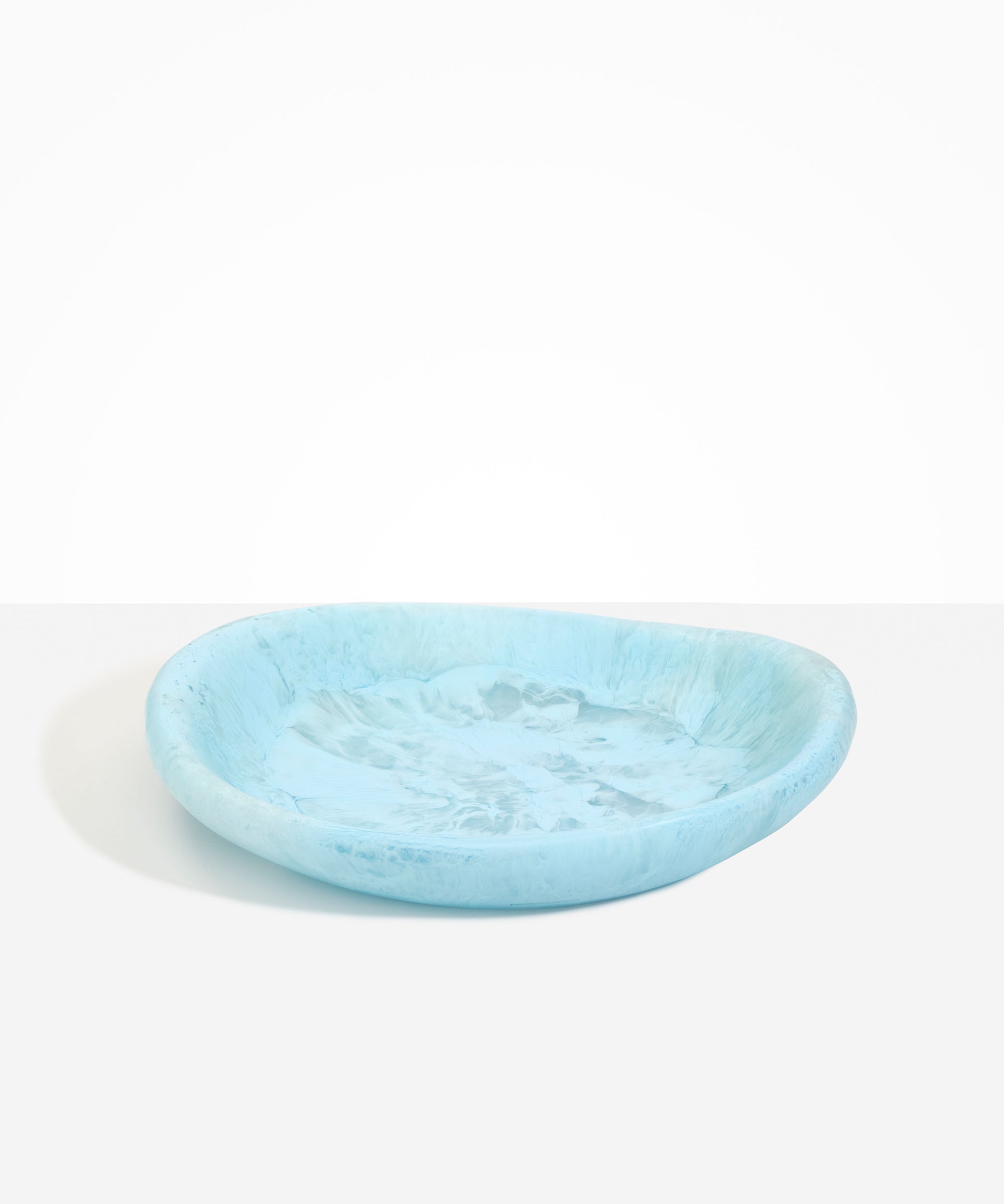 Dinosaur Designs Large Bones Bowl in Pool — handmade marbled blue resin shallow serving bowl with a rounded organic form..