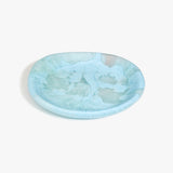 Dinosaur Designs Medium Bones Bowl in Pool — mid sized handmade marbled blue resin shallow serving bowl with a rounded organic form..