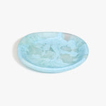 Dinosaur Designs Medium Bones Bowl in Pool — mid sized handmade marbled blue resin shallow serving bowl with a rounded organic form...