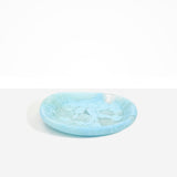 Dinosaur Designs Medium Bones Bowl in Pool — mid sized handmade marbled blue resin shallow serving bowl with a rounded organic form...