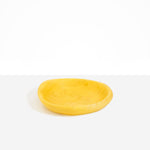 Dinosaur Designs Small Bones Bowl in Pollen — small handmade marbled yellow resin shallow serving bowl with a rounded organic form..