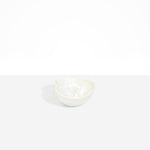 Dinosaur Designs Petal Dessert Bowl in Chalk Swirl — handcrafted marbled off-white resin bowl with curved form and pinched organic rim