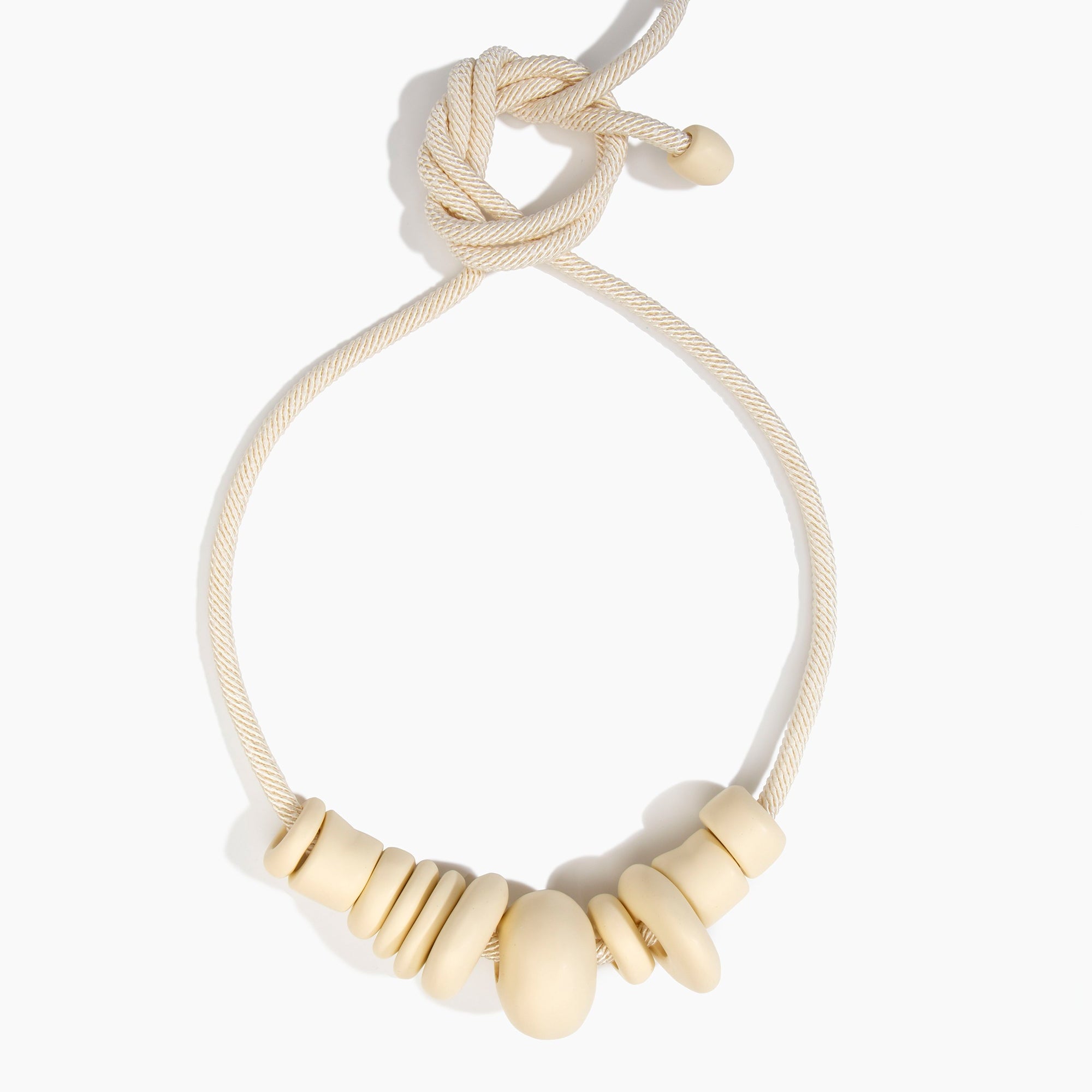 Dinosaur Designs Drift Choker in Cream with Plated-Silver — cream resin pebble beads on a wood silk cord with silver-plated end cap.