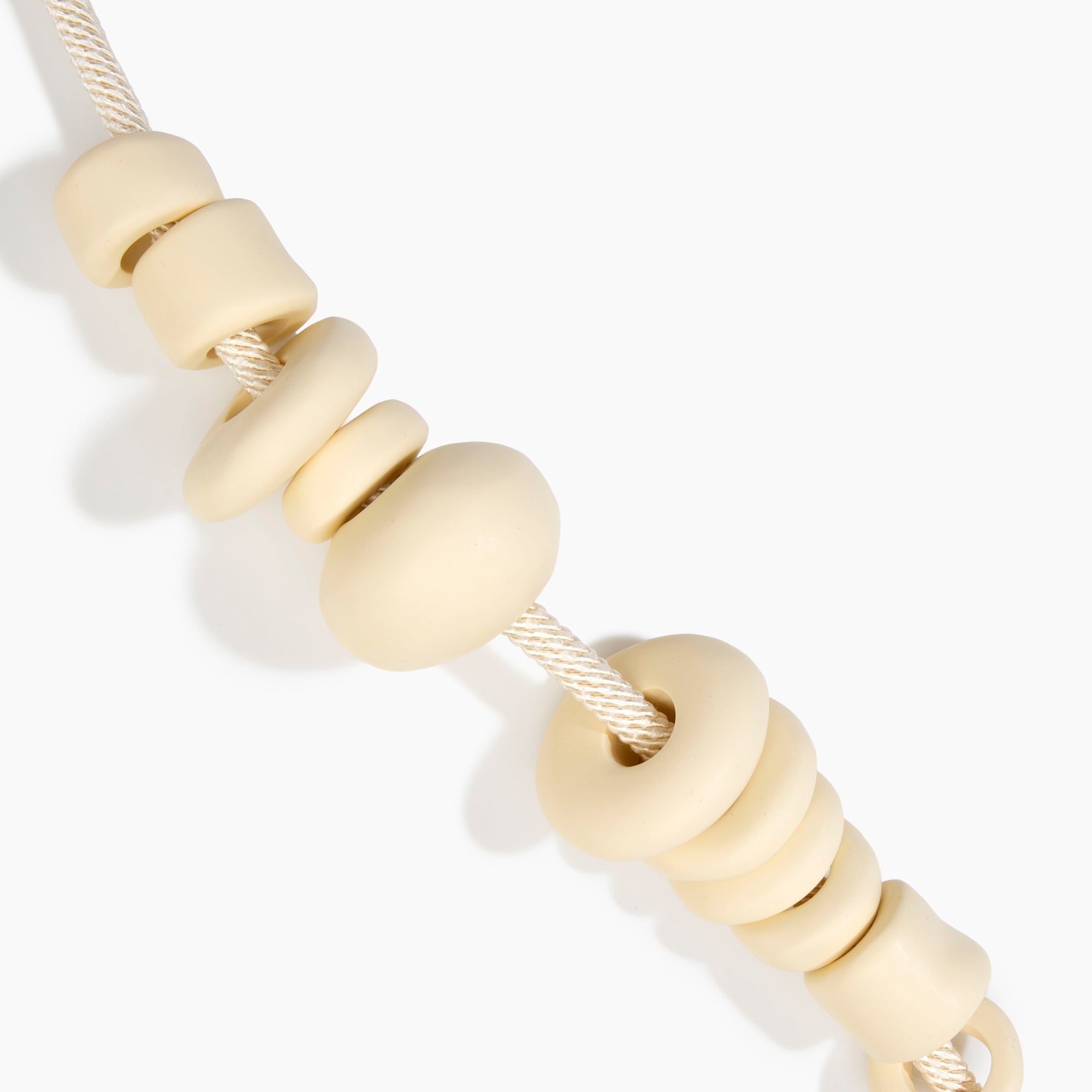 Dinosaur Designs Drift Choker in Cream with Plated-Silver — cream resin pebble beads on a wood silk cord with silver-plated end cap.
