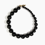 Dinosaur Designs Polished Organic Ball Choker in Black — handcrafted black polished resin graduating bead choker necklace with brass t-bar clasp.
