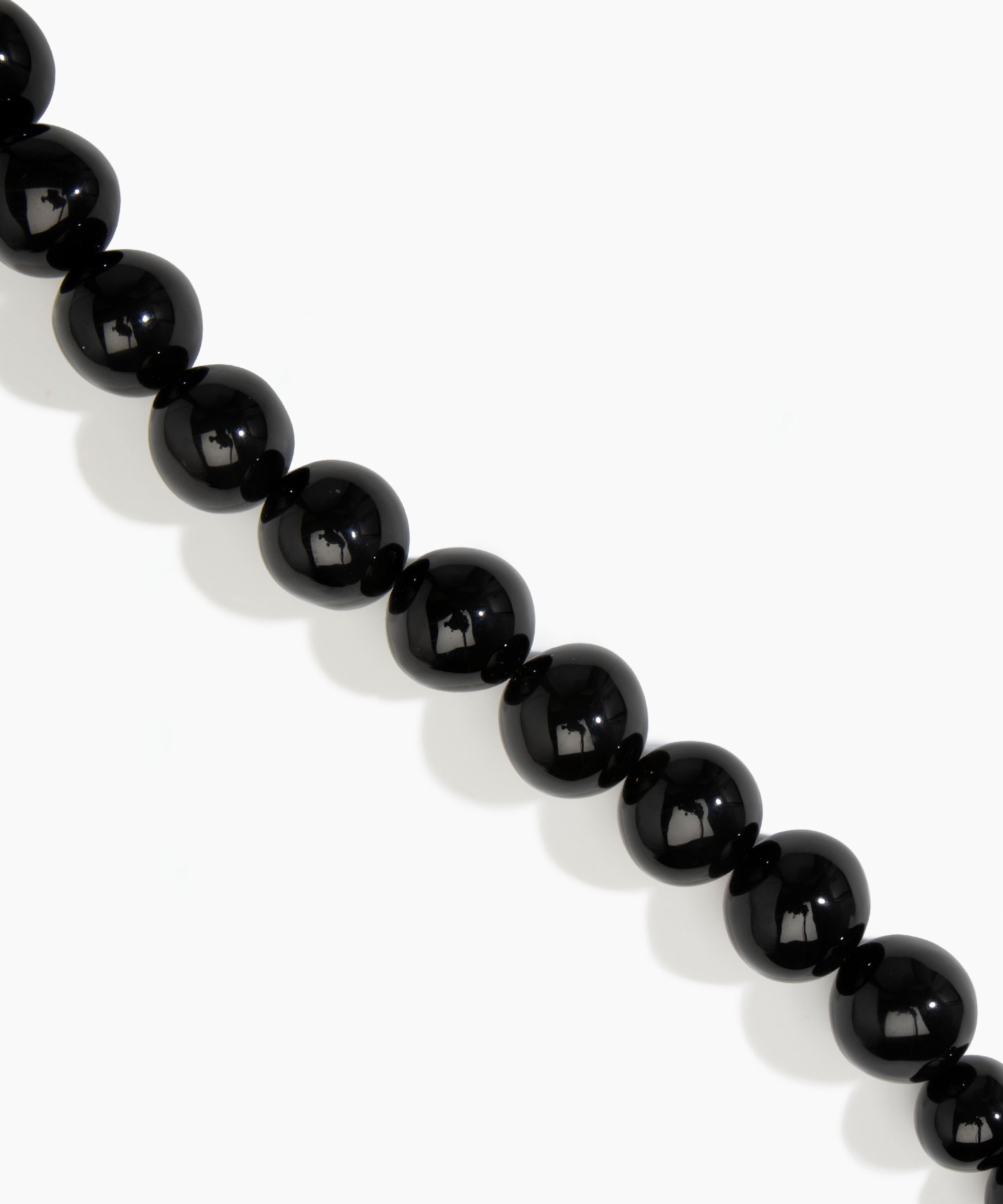 Dinosaur Designs Polished Organic Ball Choker in Black — handcrafted black polished resin graduating bead choker necklace with brass t-bar clasp.