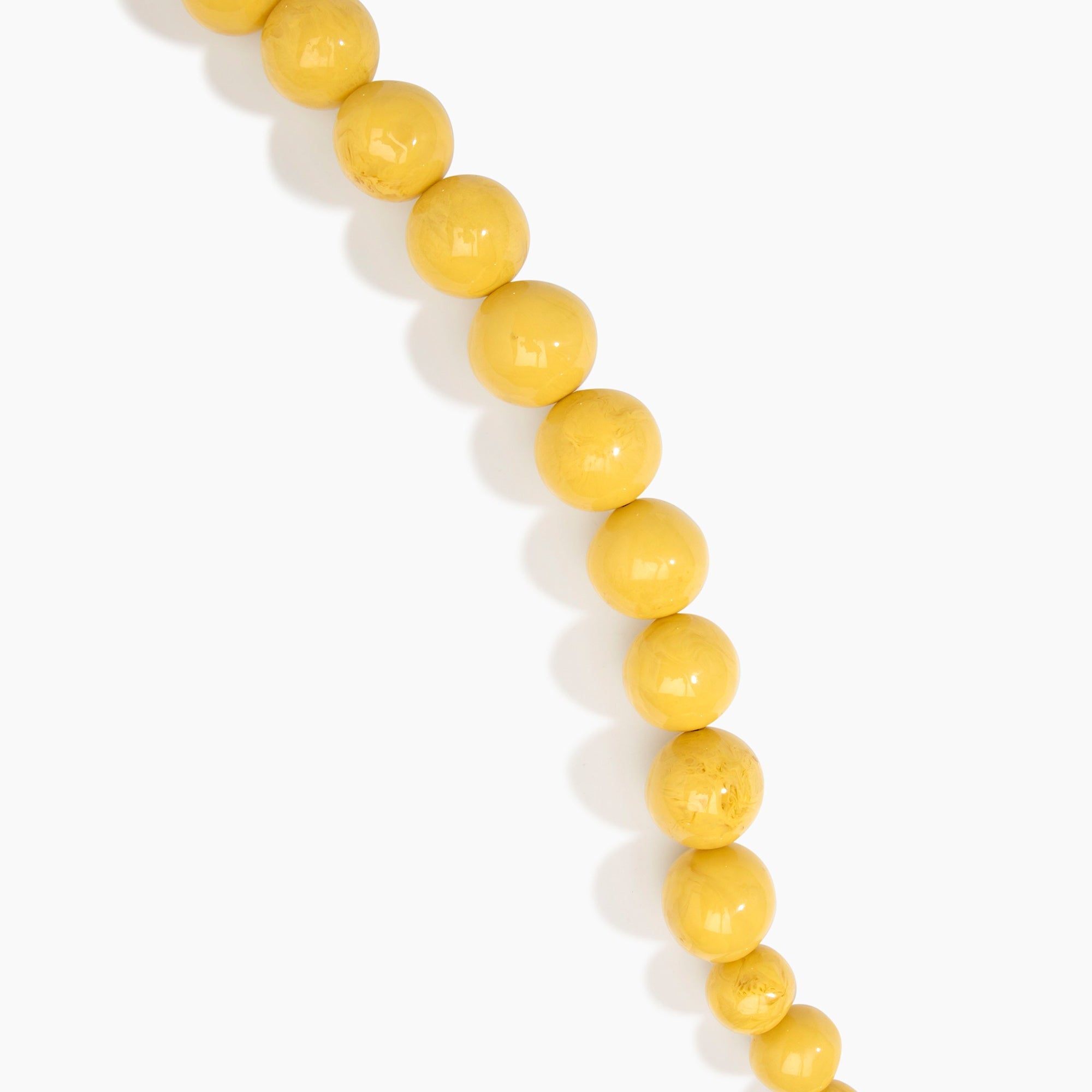 Dinosaur Designs Polished Organic Ball Choker in Pollen — handcrafted marbled yellow and clear polished resin graduating bead choker necklace with brass t-bar clasp