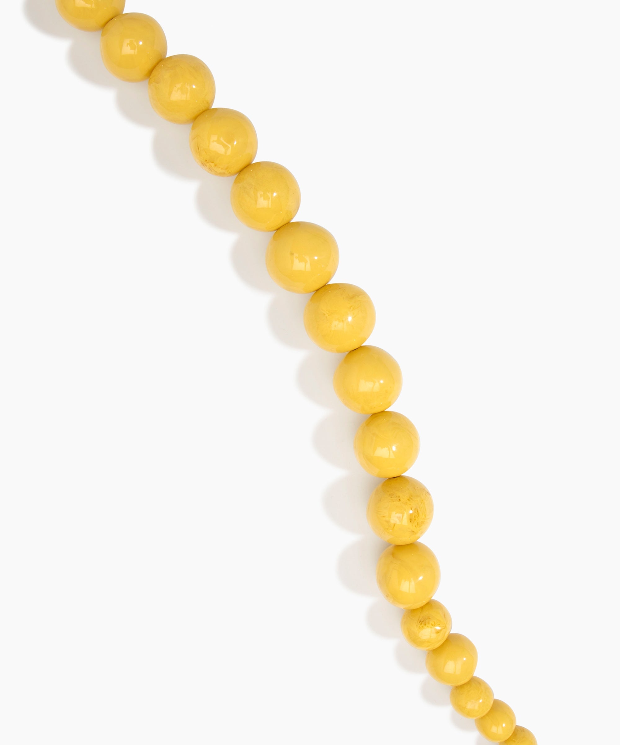 Dinosaur Designs Polished Organic Ball Choker in Pollen — handcrafted marbled yellow and clear polished resin graduating bead choker necklace with brass t-bar clasp