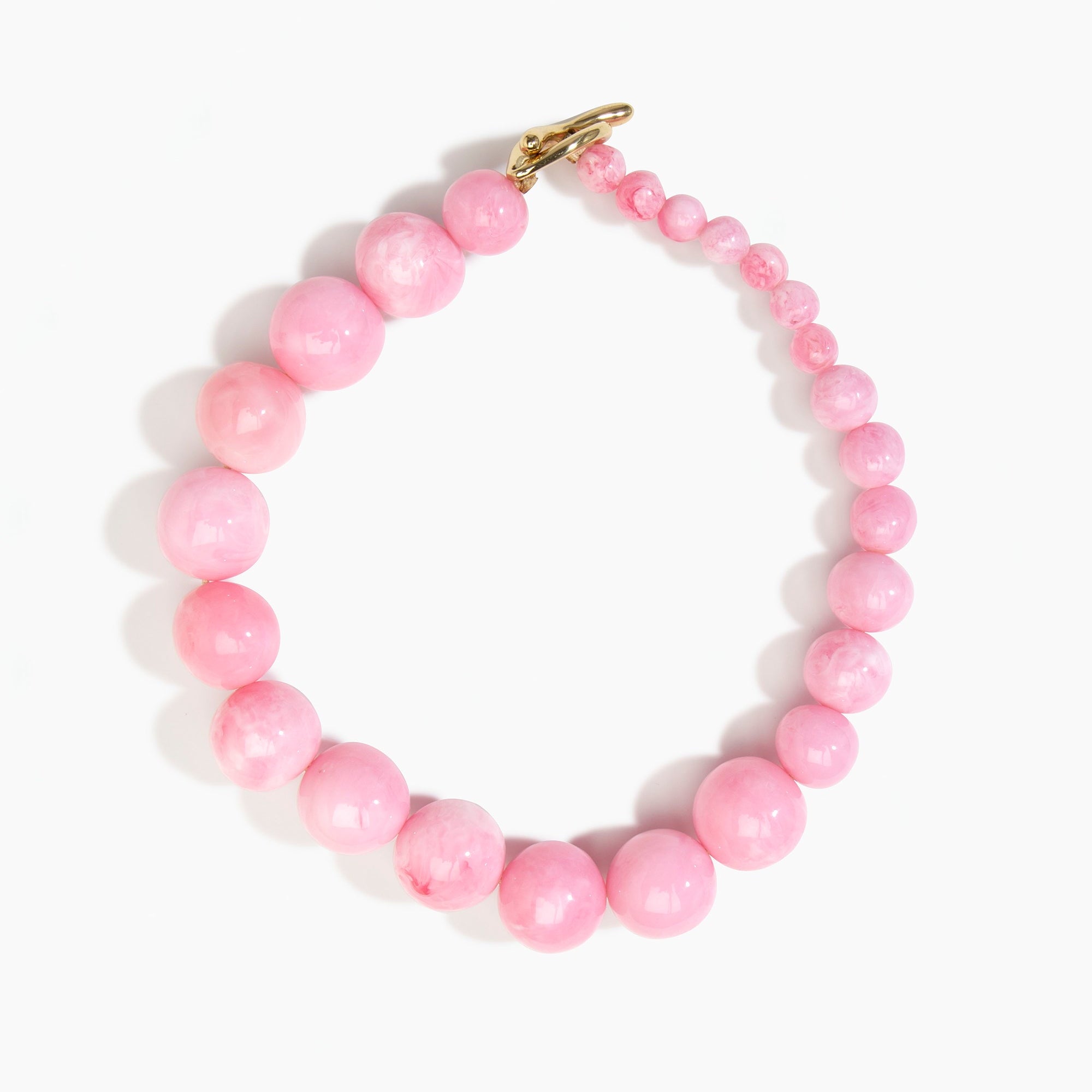 Dinosaur Designs Polished Organic Ball Choker in Shell Pink — handcrafted marbled pink polished resin graduating bead choker necklace with brass t-bar clasp..