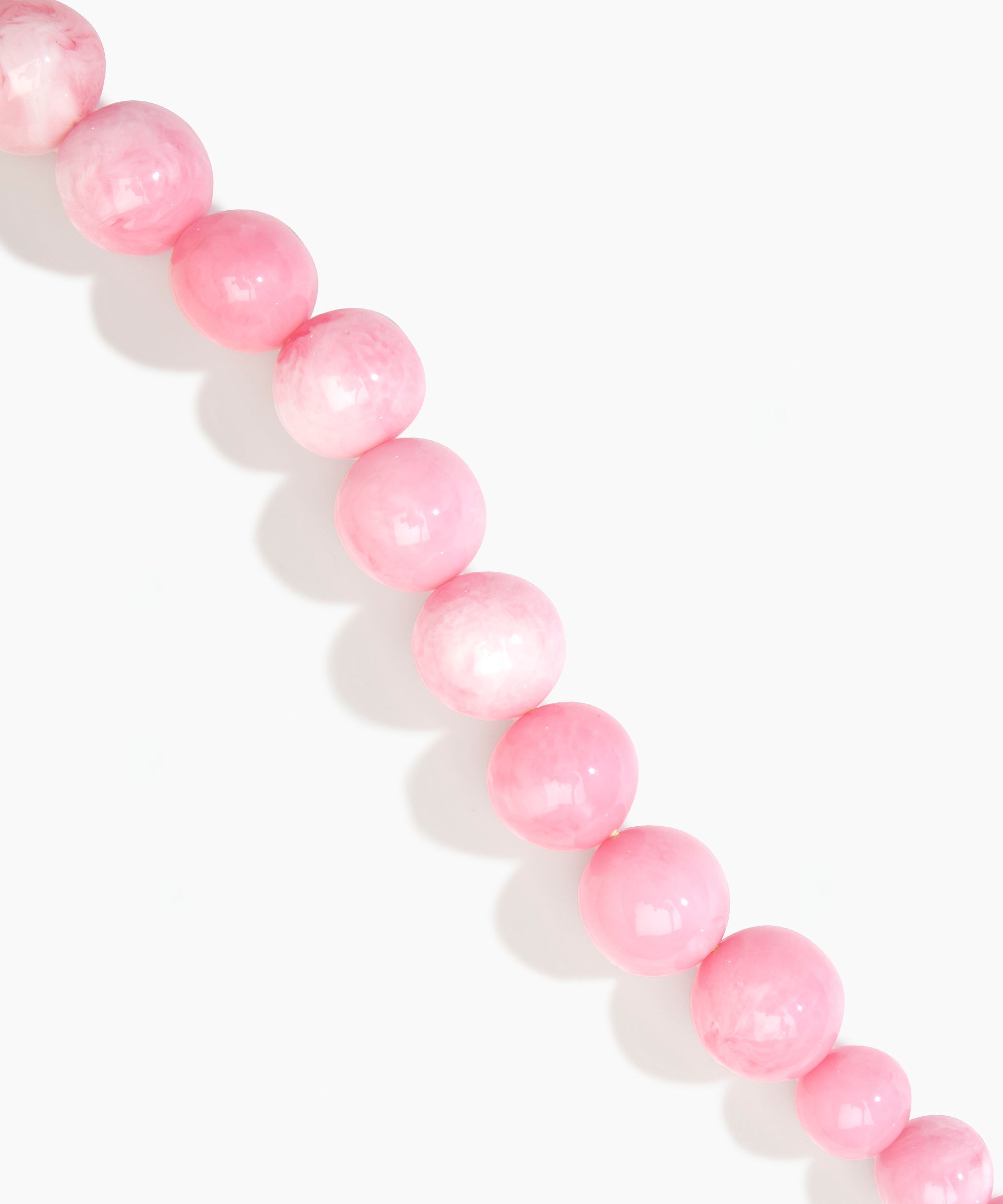 Dinosaur Designs Polished Organic Ball Choker in Shell Pink — handcrafted marbled pink polished resin graduating bead choker necklace with brass t-bar clasp.