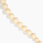 Dinosaur Designs Polished Organic Ball Choker in Cream — handcrafted cream polished resin graduating bead choker necklace with brass t-bar clasp.