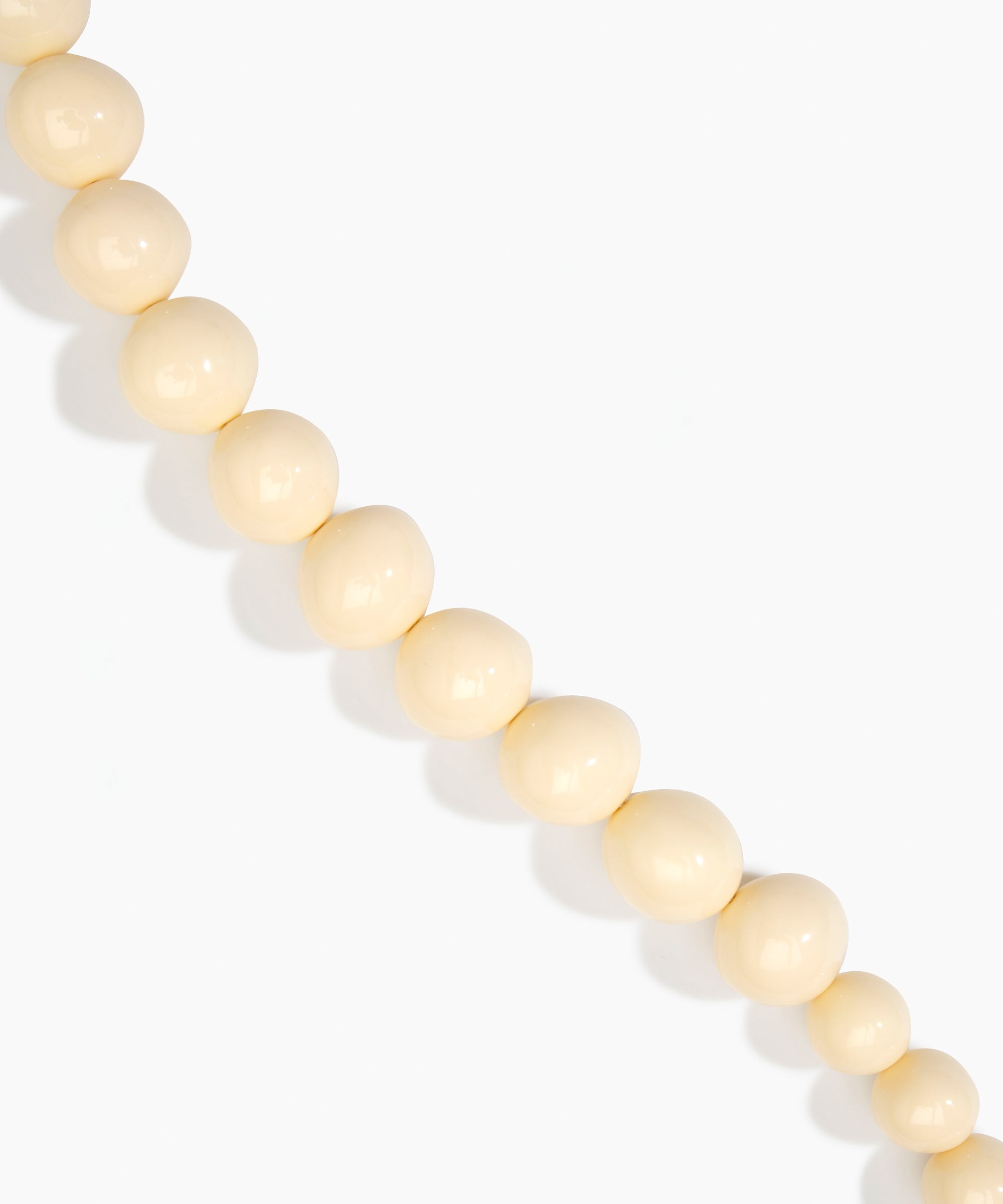 Dinosaur Designs Polished Organic Ball Choker in Cream — handcrafted cream polished resin graduating bead choker necklace with brass t-bar clasp.
