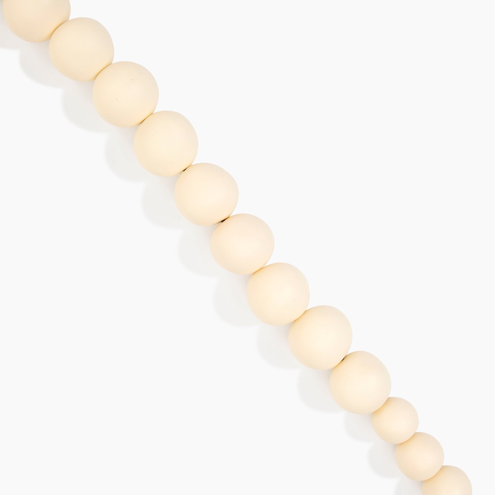 Dinosaur Designs Organic Ball Choker in Cream — handcrafted cream matte resin graduating bead choker necklace with silver t-bar clasp.