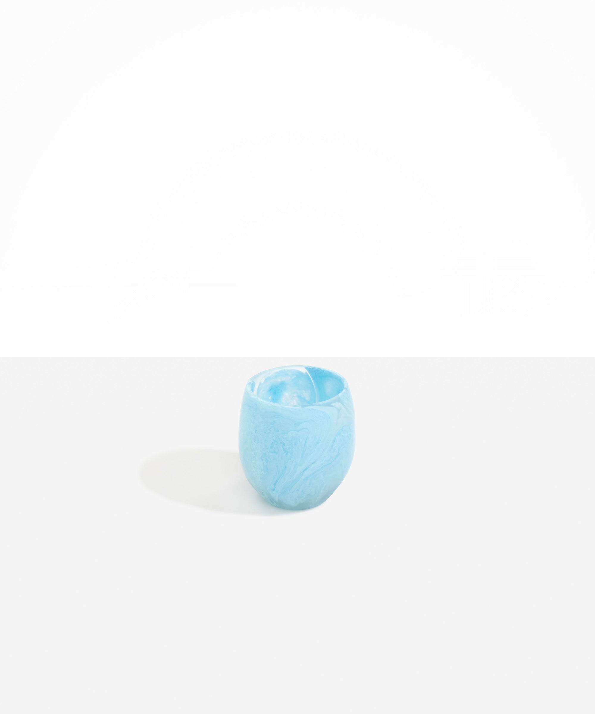 Dinosaur Designs Large Rock Cup in Pool — handcrafted marbled blue and transparent resin cup with rounded bulbous form and open organic rim..