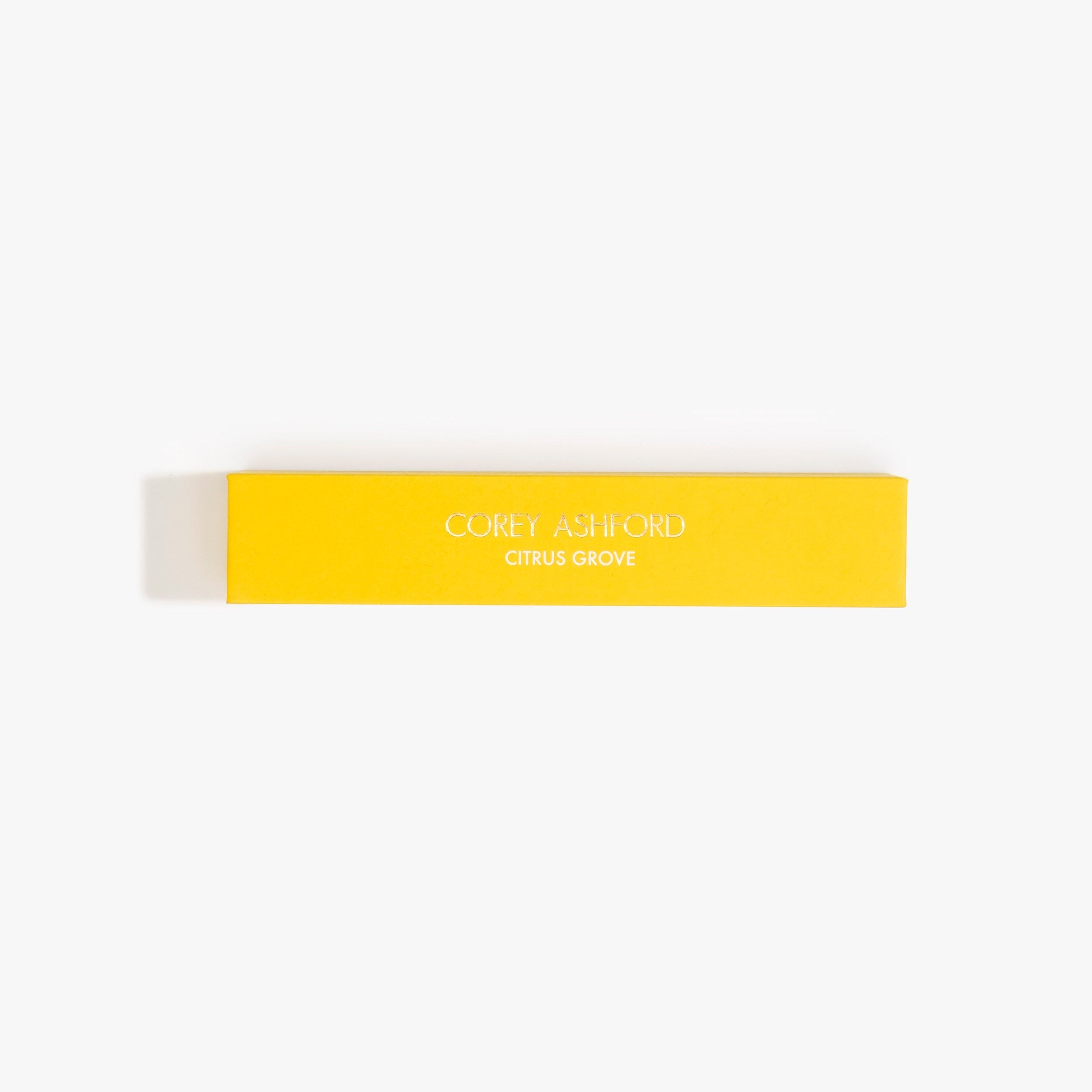 Dinosaur Designs Corey Ashford Citrus Grove Japanese Incense — yellow box of sandalwood, yuzu and orange scented incense sticks.