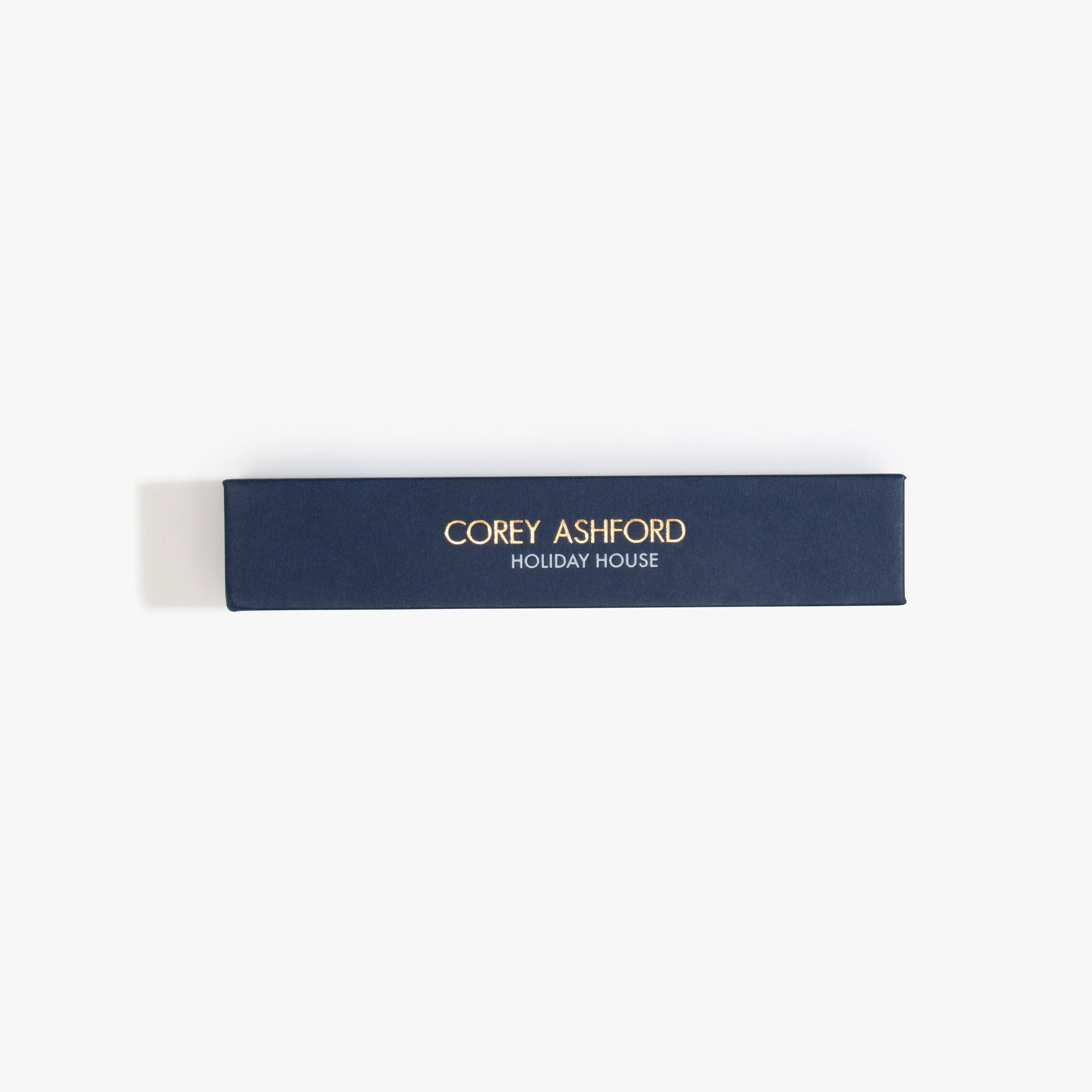 Dinosaur Designs Corey Ashford Holiday House Japanese Incense — blue box of sandalwood, cedar and pine scented incense sticks.