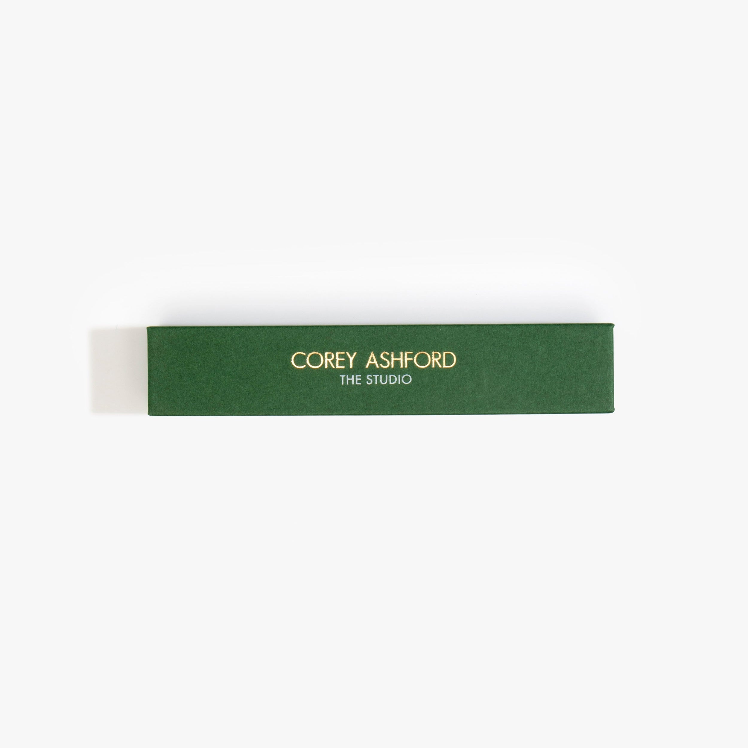 Dinosaur Designs Corey Ashford The Studio Japanese Incense — green box of labdanum, frankincense and charcoal scented incense sticks.