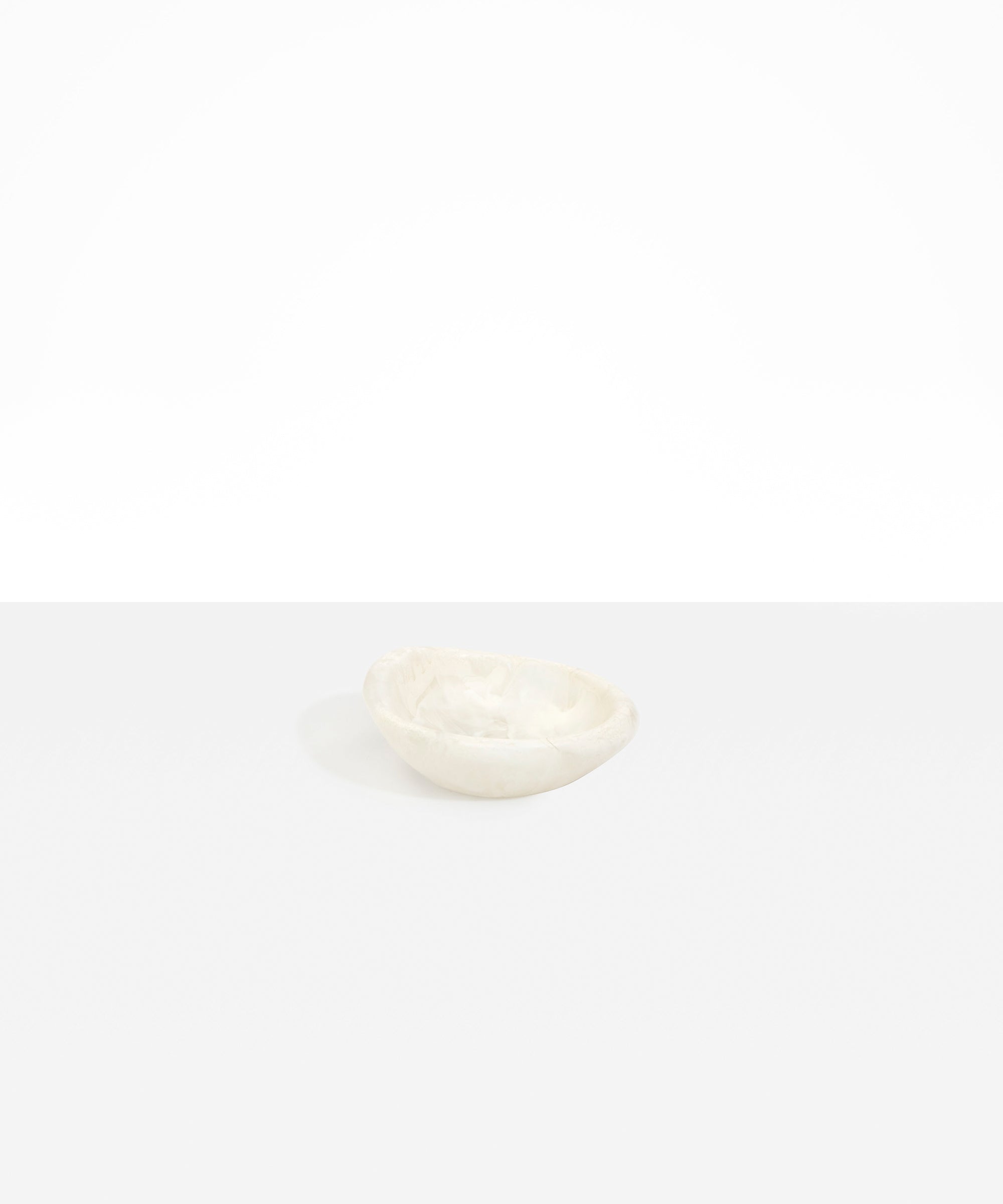 Dinosaur Designs Bones Dish in Chalk Swirl — small handcrafted marbled off-white resin trinket dish with organic form