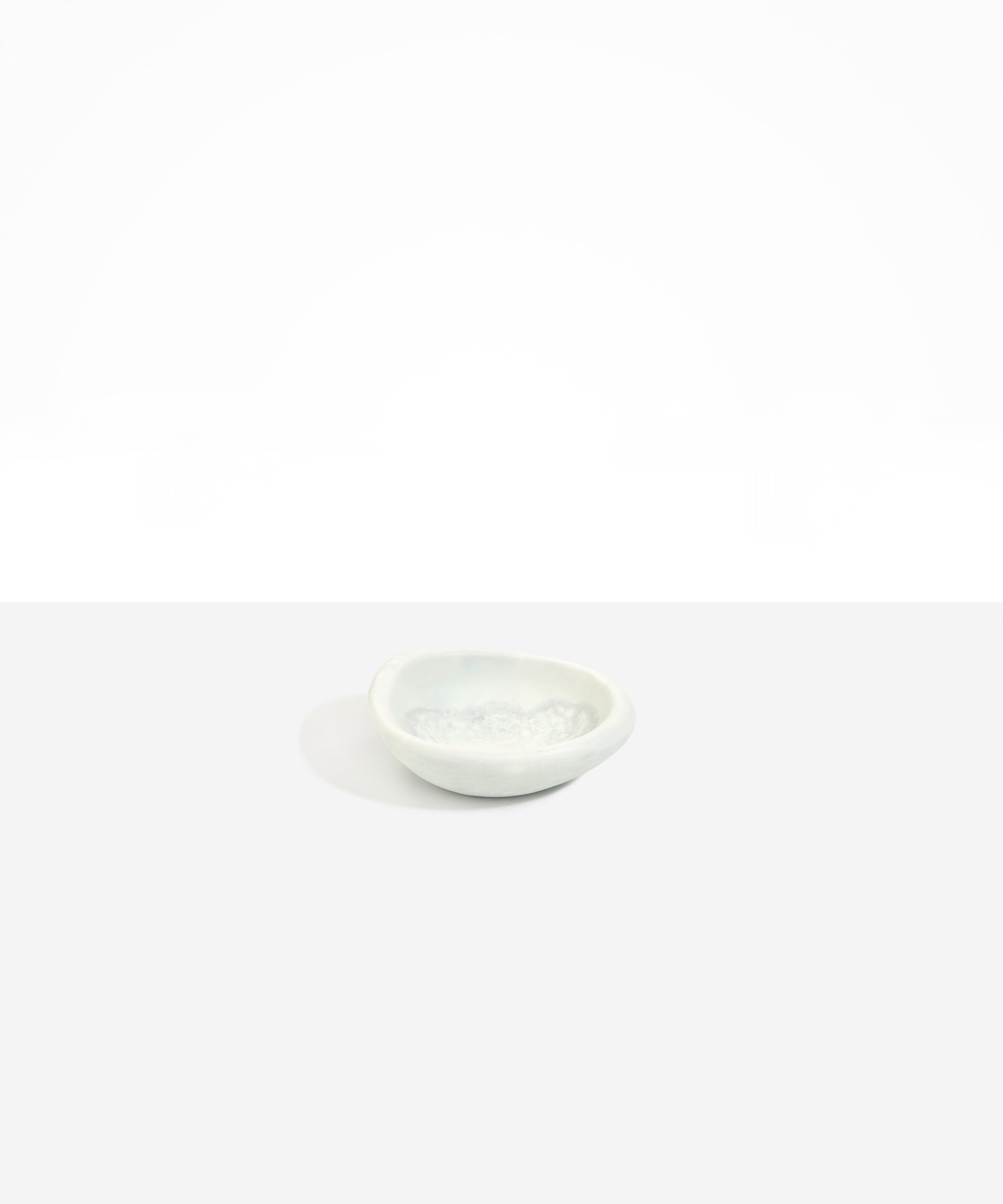 Dinosaur Designs Bones Dish in Cloud — small handcrafted grey and cream marbled resin trinket dish with organic form..