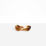 Dinosaur Designs Bones Dish in Light Horn — handcrafted marbled brown, cream and translucent resin trinket dish with pinched bone-shaped organic form