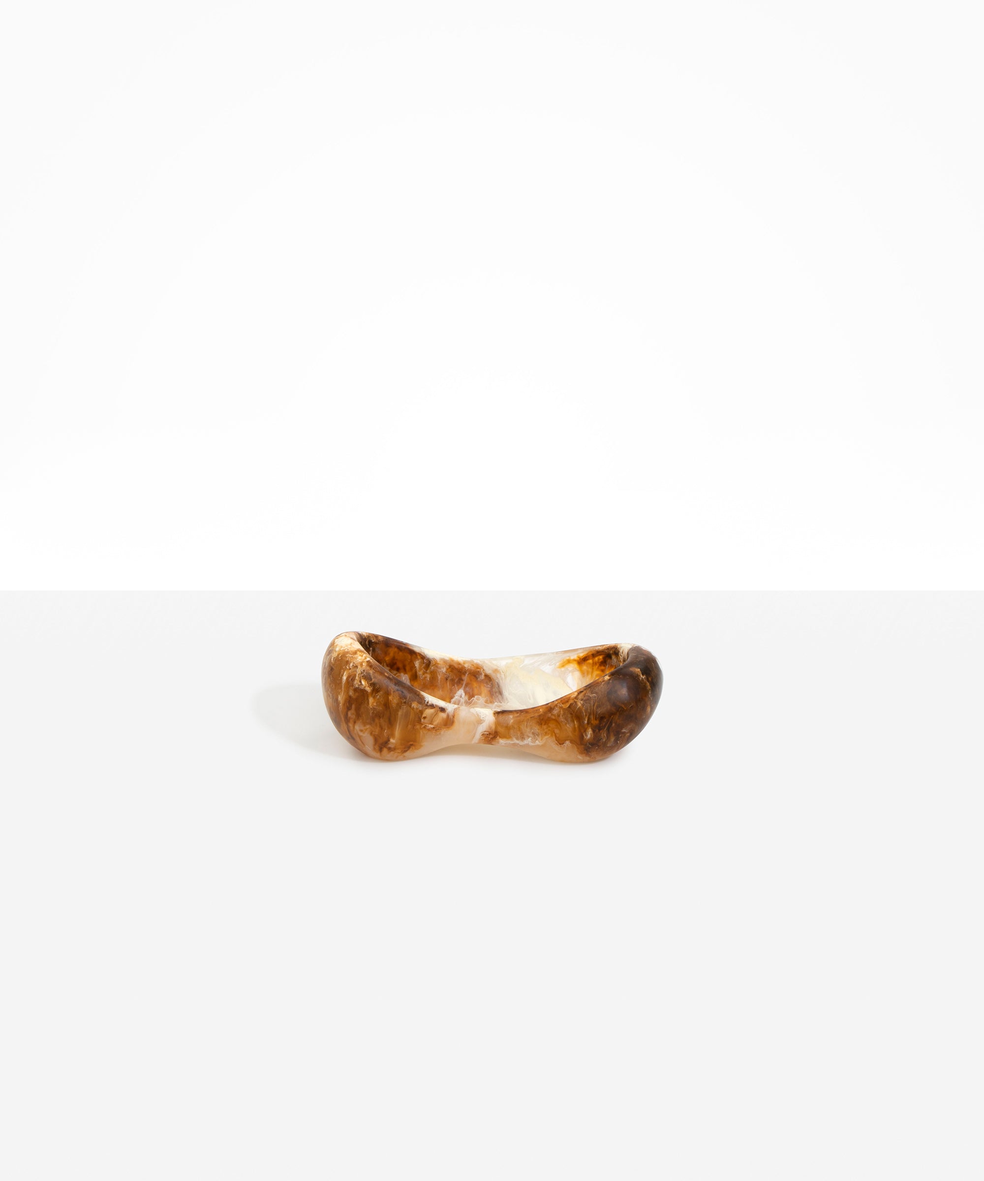Dinosaur Designs Bones Dish in Light Horn — handcrafted marbled brown, cream and translucent resin trinket dish with pinched bone-shaped organic form