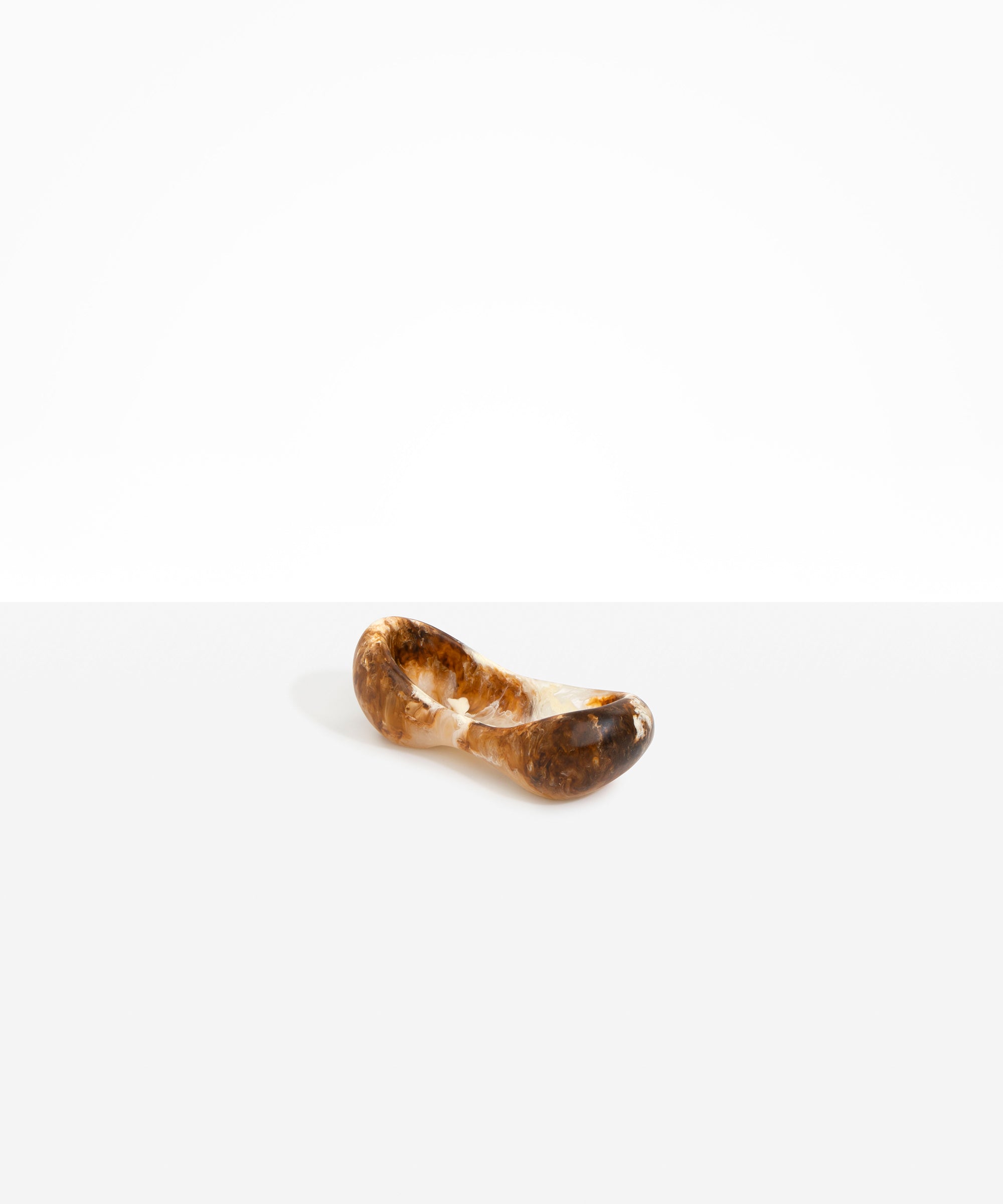 Dinosaur Designs Bones Dish in Light Horn — handcrafted marbled brown, cream and translucent resin trinket dish with pinched bone-shaped organic form