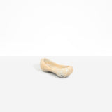 Dinosaur Designs Bones Dish in Sandy Pearl — handcrafted marbled beige and pearlescent resin trinket dish with pinched bone-shaped organic form