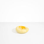 Dinosaur Designs Drift Dish in Daisy— handcrafted marbled light and dark yellow resin chunky trinket dish with organic form