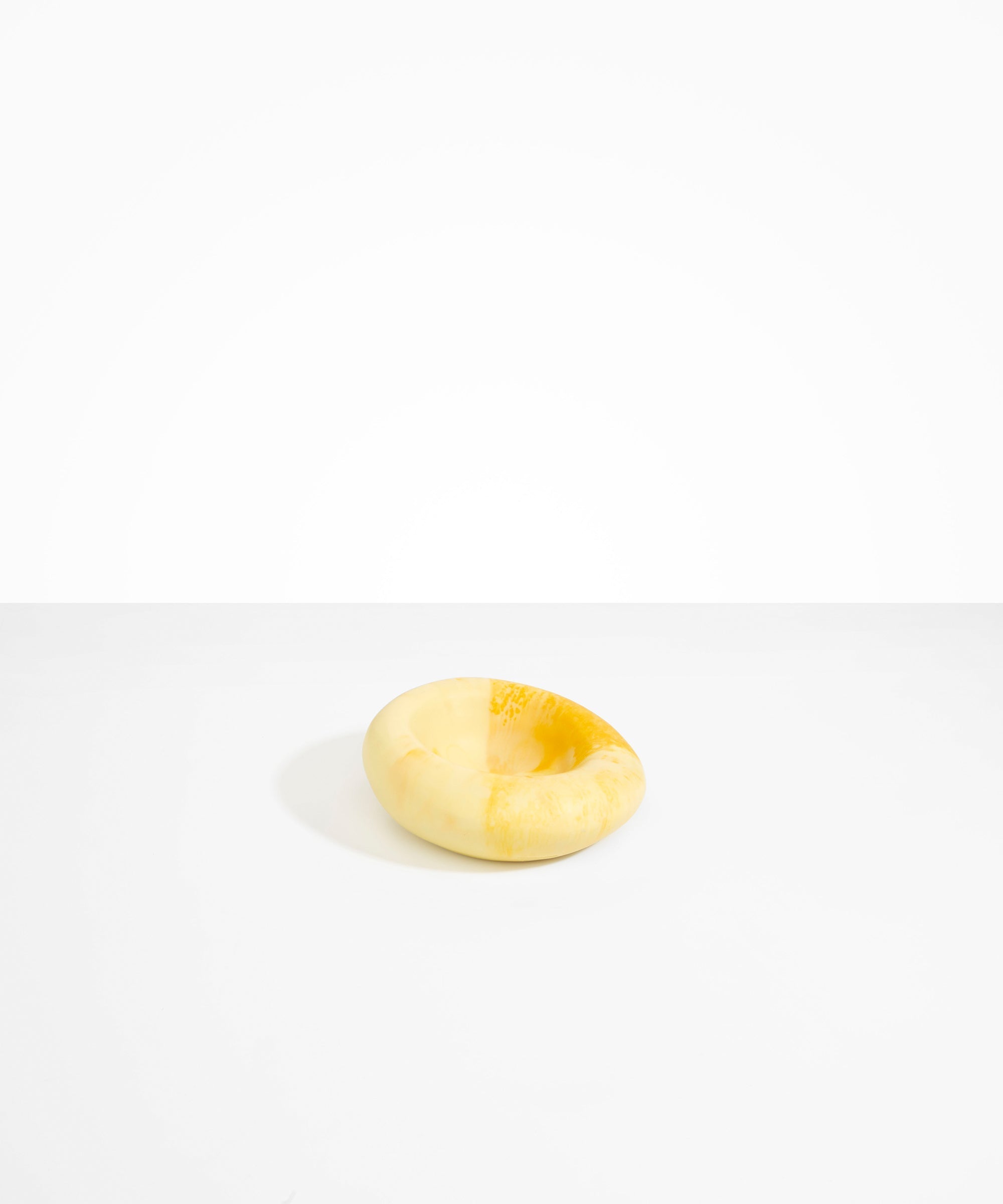 Dinosaur Designs Drift Dish in Daisy— handcrafted marbled light and dark yellow resin chunky trinket dish with organic form