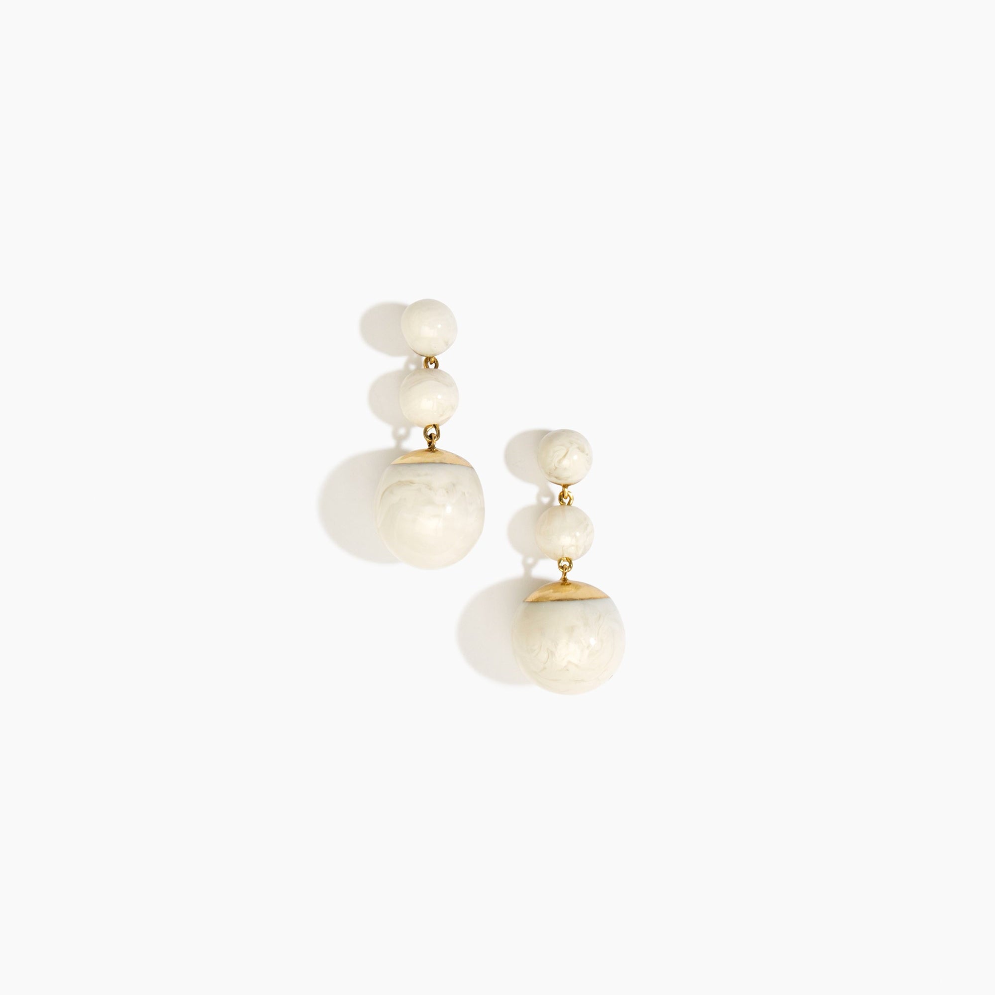 Dinosaur Designs Full Moon Drop Earrings in Chalk Swirl with Brass — marbled off-white resin graduating bead drop earrings with brass fittings..