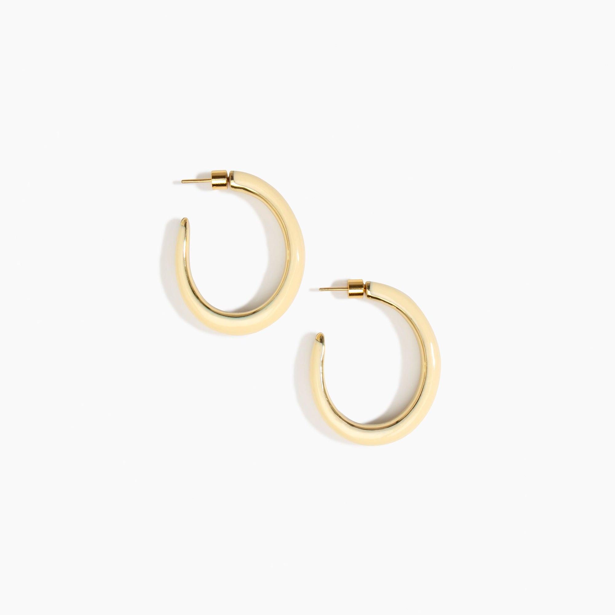 Dinosaur Designs Large Pebble Duo Hoop Earrings in Cream — cream resin hoop earrings with polished brass inner face and stud fastening.