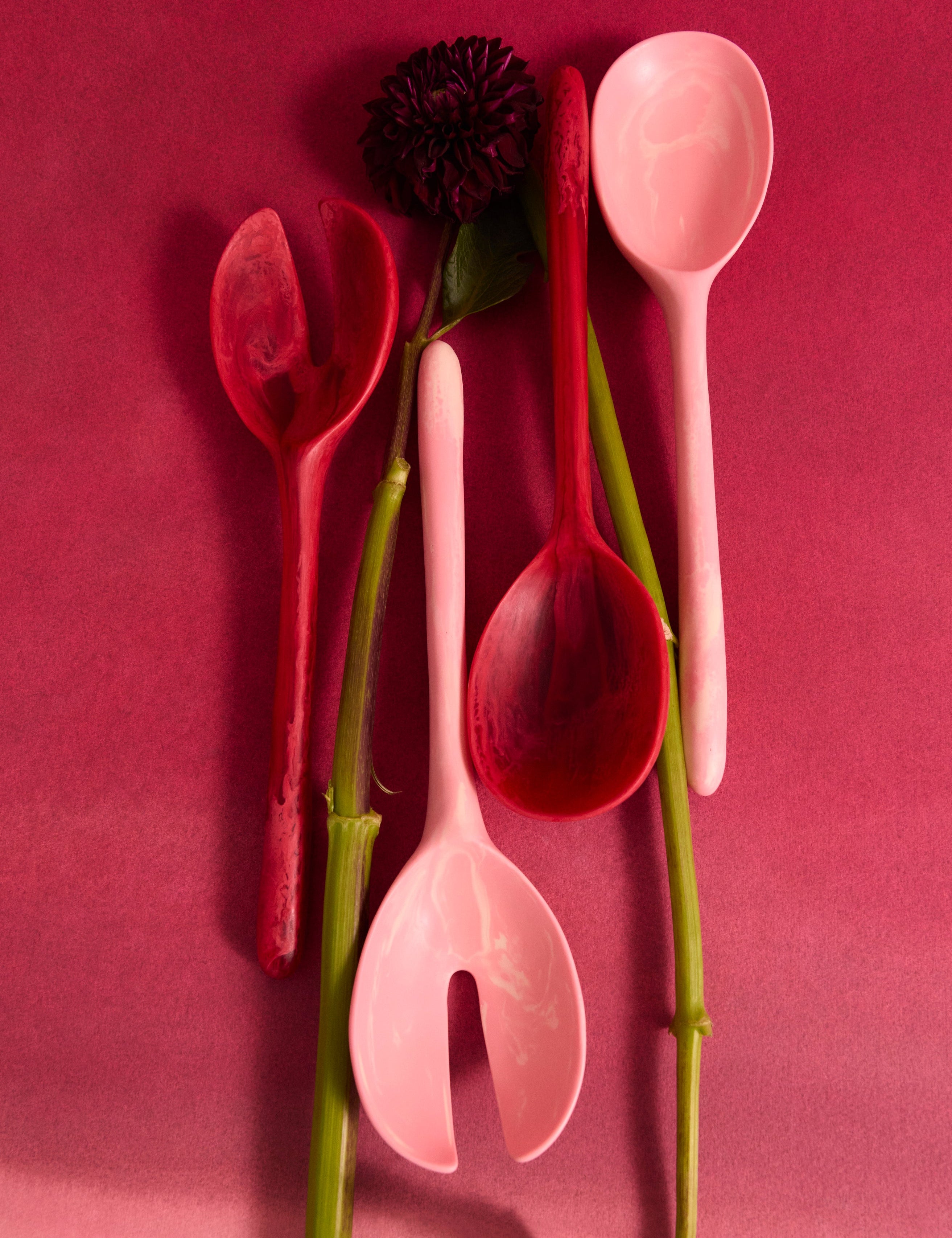 Pink and red resin serving spoon with a single flower stem