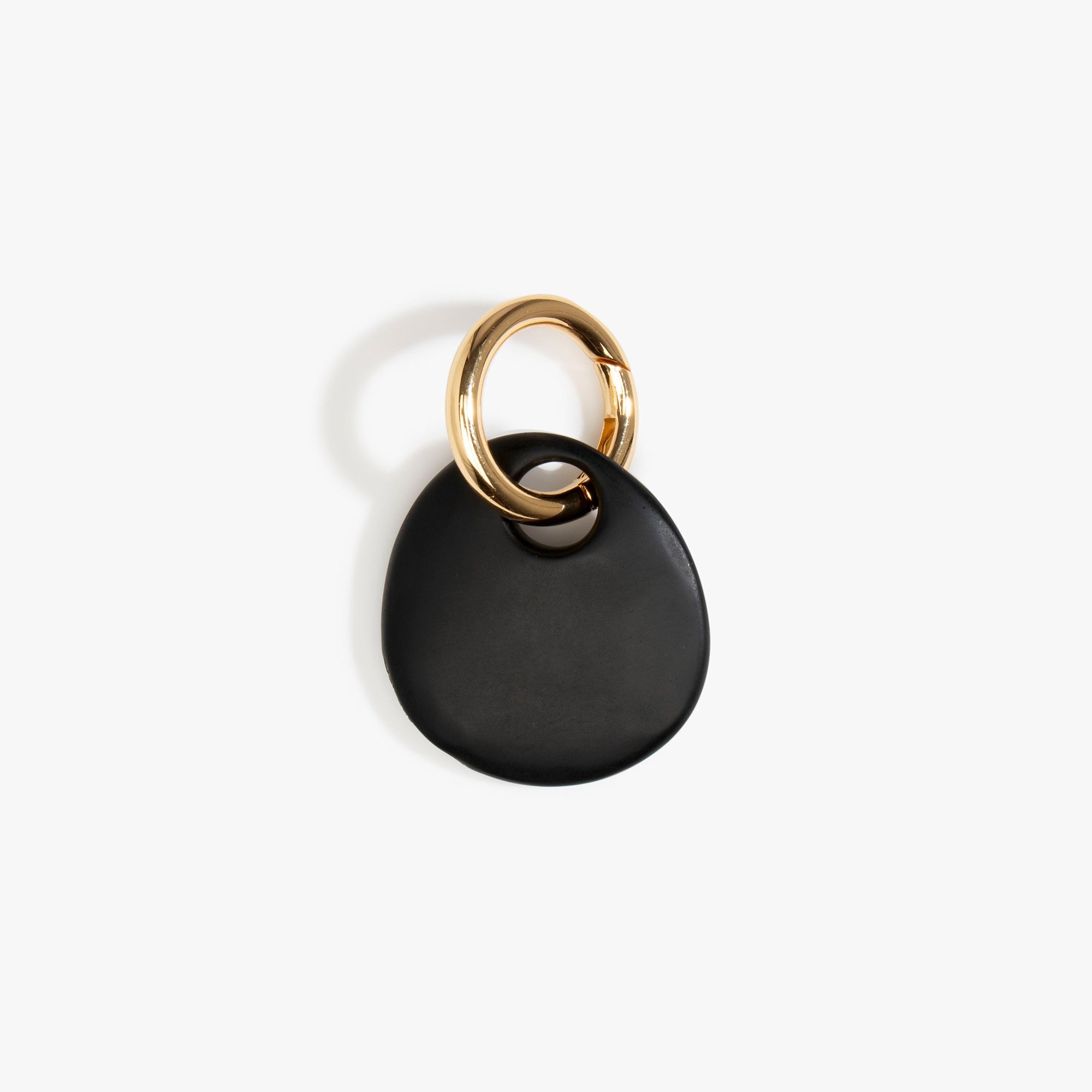 Dinosaur Designs Earth Keyring in Black — handcrafted Black resin pebble bead on a polished brass jump ring..