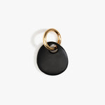 Dinosaur Designs Earth Keyring in Black — handcrafted Black resin pebble bead on a polished brass jump ring..