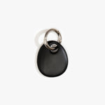 Dinosaur Designs Earth Keyring in Black — handcrafted Black resin pebble bead on a polished gunmetal jump ring..
