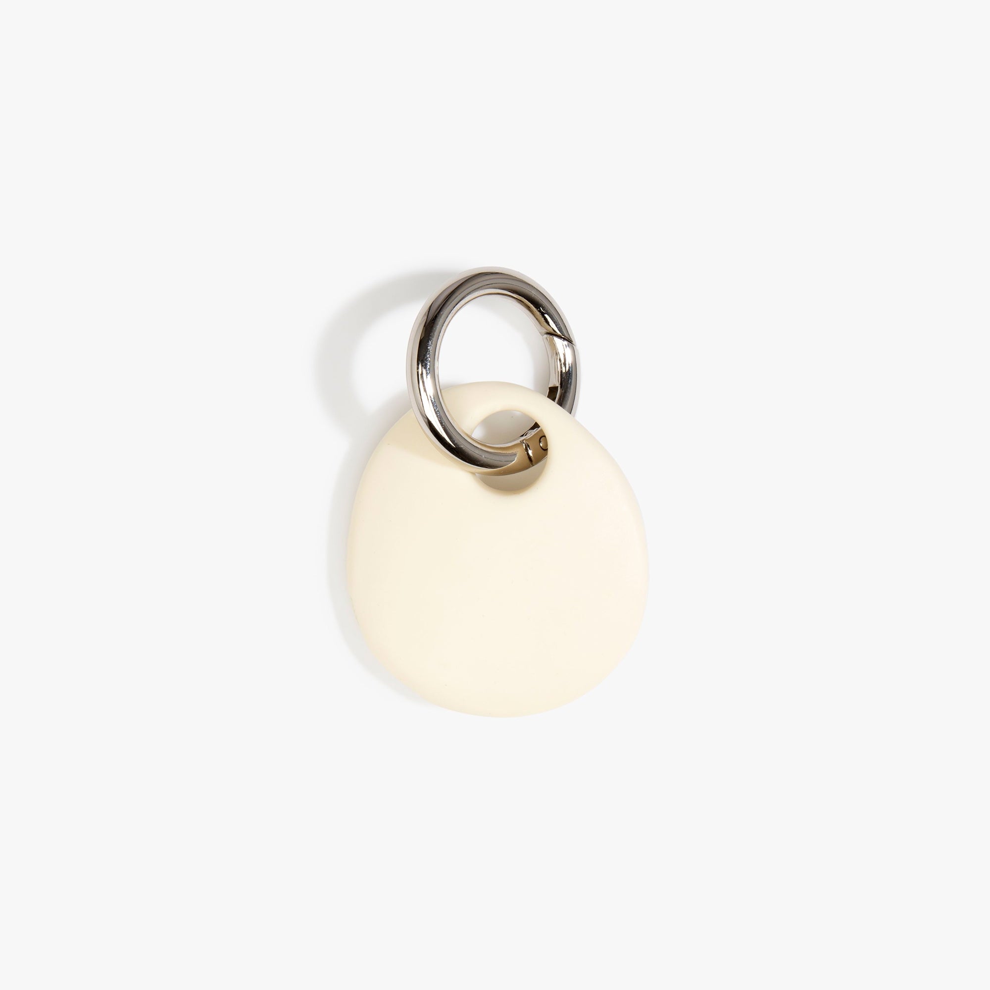 Dinosaur Designs Earth Keyring in Cream — handcrafted Cream resin pebble bead on a polished gunmetal jump ring..