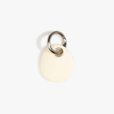 Dinosaur Designs Earth Keyring in Cream — handcrafted Cream resin pebble bead on a polished gunmetal jump ring..