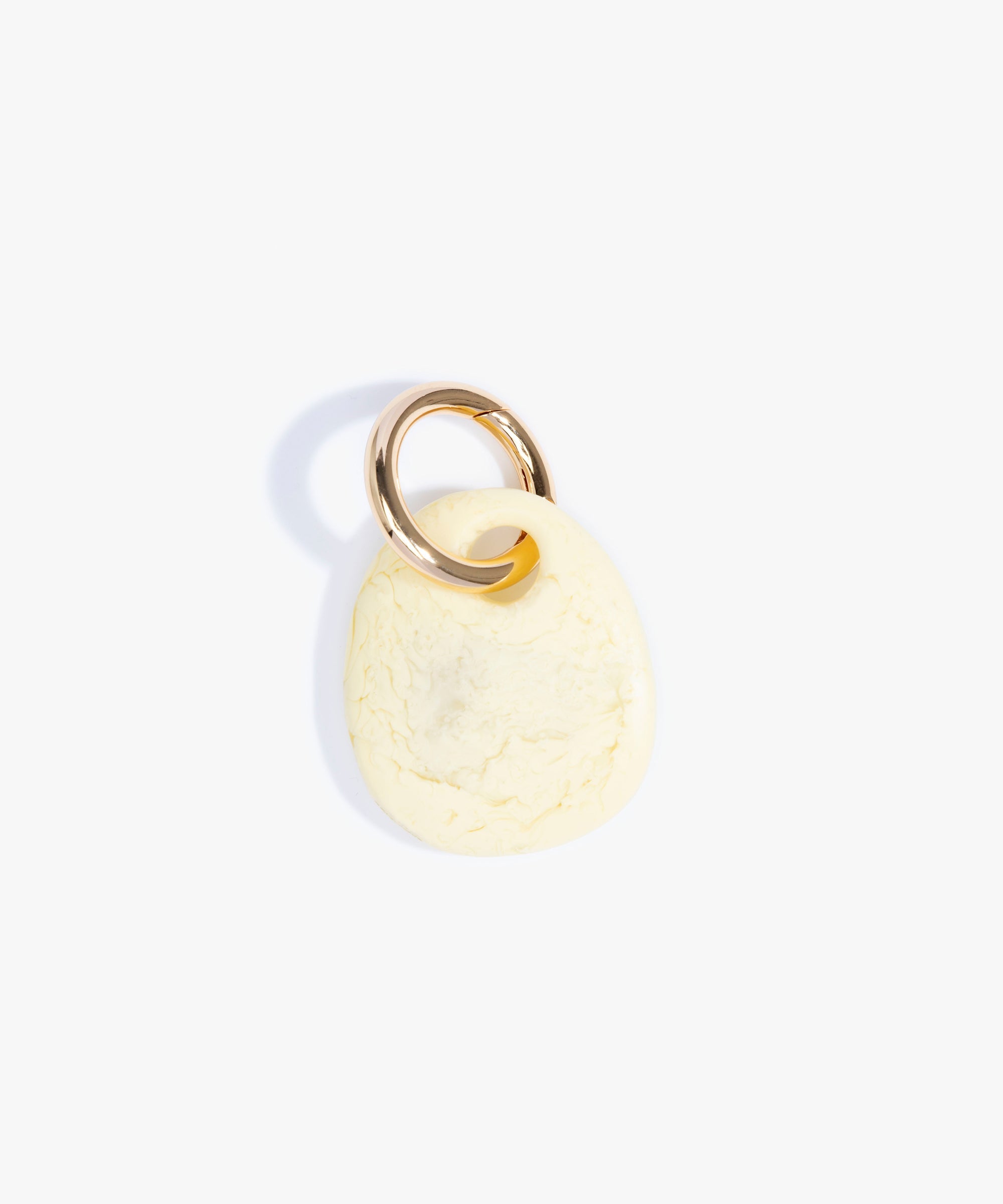 Dinosaur Designs Earth Keyring in Lemon — handcrafted marbled pastel yellow resin pebble bead on a polished brass jump ring..