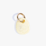 Dinosaur Designs Earth Keyring in Lemon — handcrafted marbled pastel yellow resin pebble bead on a polished brass jump ring..