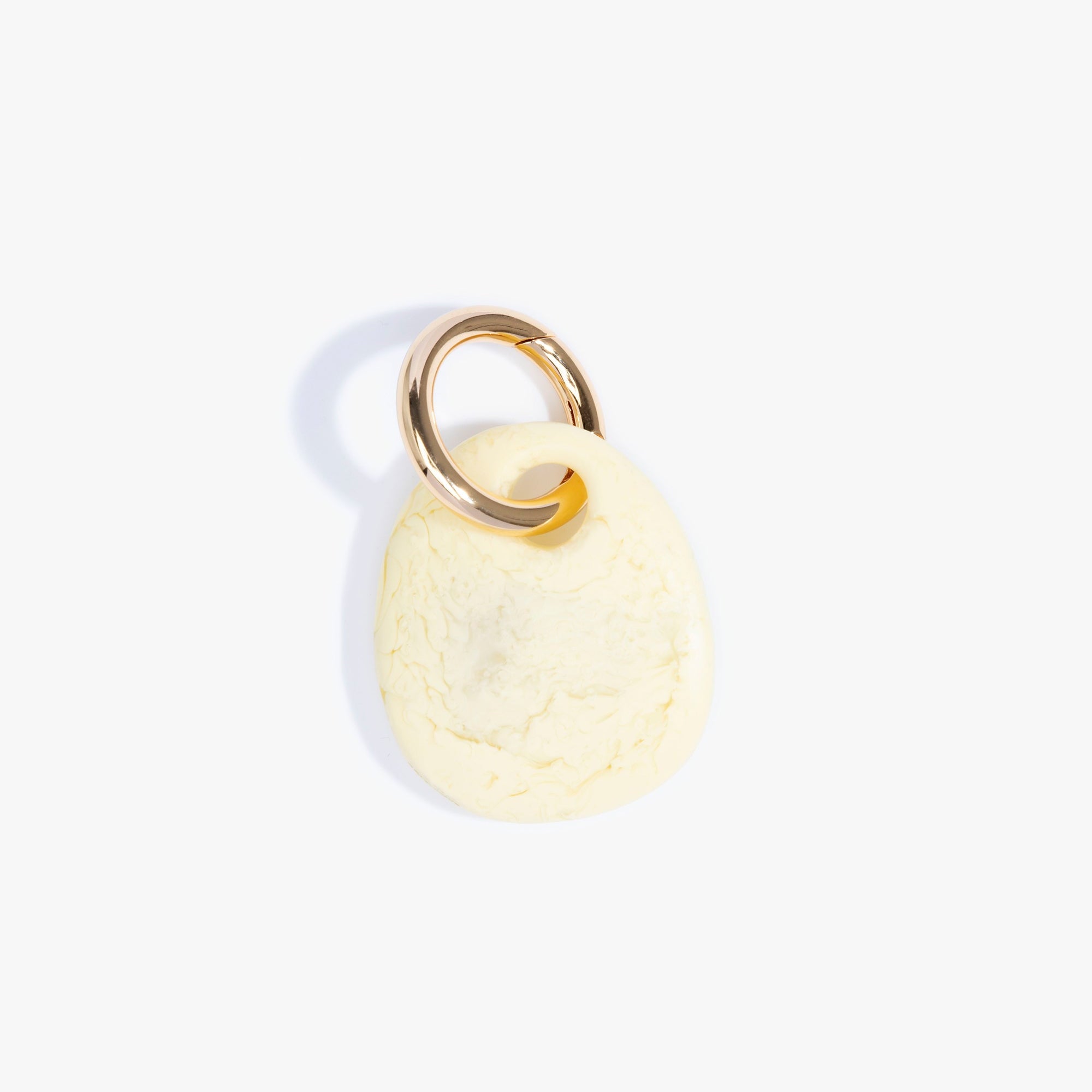 Dinosaur Designs Earth Keyring in Lemon — handcrafted marbled pastel yellow resin pebble bead on a polished brass jump ring..
