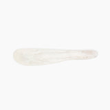 Dinosaur Designs Temple Cake Knife in Chalk Swirl — handcrafted marbled off white resin cake knife with smooth tapered blade and rounded handle.