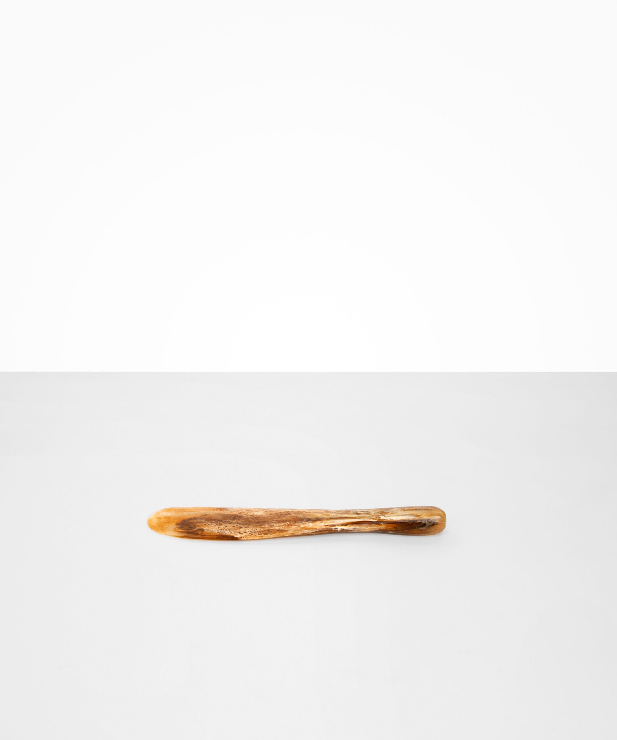 Dinosaur Designs Temple Cake Knife in Light Horn — handcrafted marbled brown, cream and clear resin cake knife with smooth tapered blade and rounded handle.
