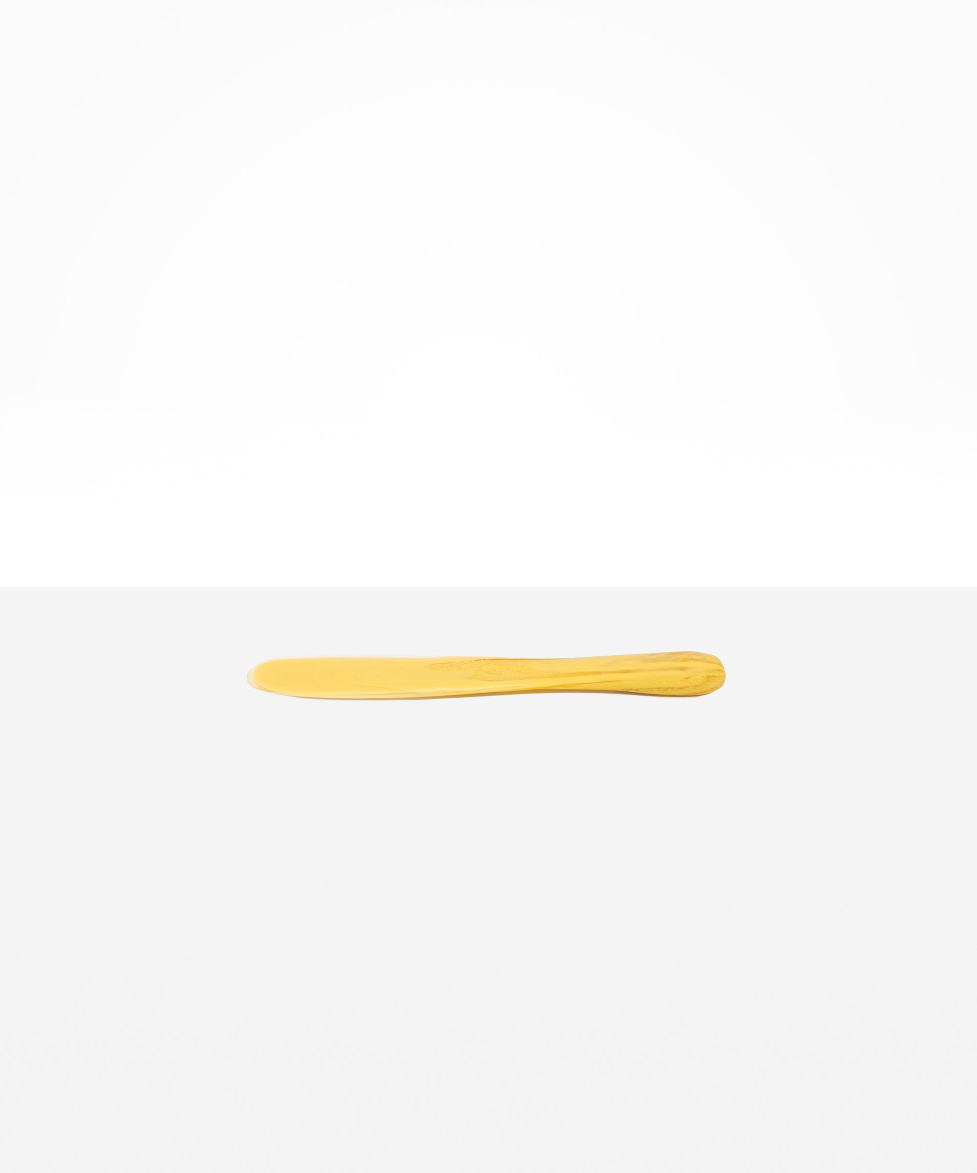 Dinosaur Designs Temple Cake Knife in Pollen — handcrafted marbled yellow and clear resin cake knife with smooth tapered blade and rounded handle.