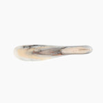 Dinosaur Designs Temple Cake Knife in Sandy Pearl — handcrafted marbled beige, grey and pearlescent resin cake knife with smooth tapered blade and rounded handle.