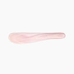 Dinosaur Designs Temple Cake Knife in Shell Pink — handcrafted marbled pale pink resin cake knife with smooth tapered blade and rounded handle.
